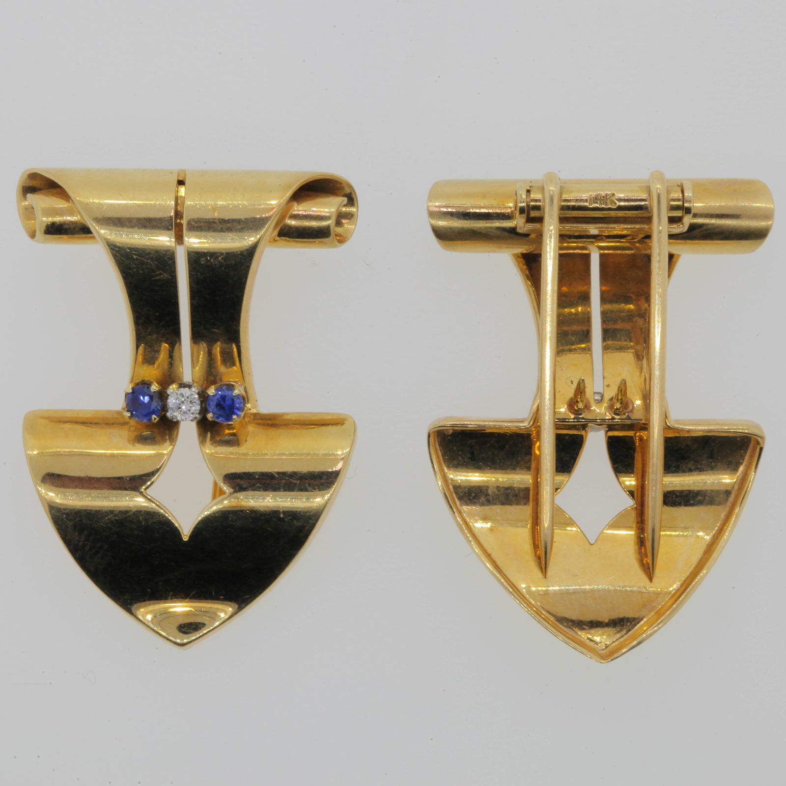 Stylish 1940s 14KT yellow gold clips/brooches.  A 0.07 carat white Diamond and two Ceylon Sapphires weighing 0.40 carat accent these classic Retro clips.  A perfect accessory to your business suit.  