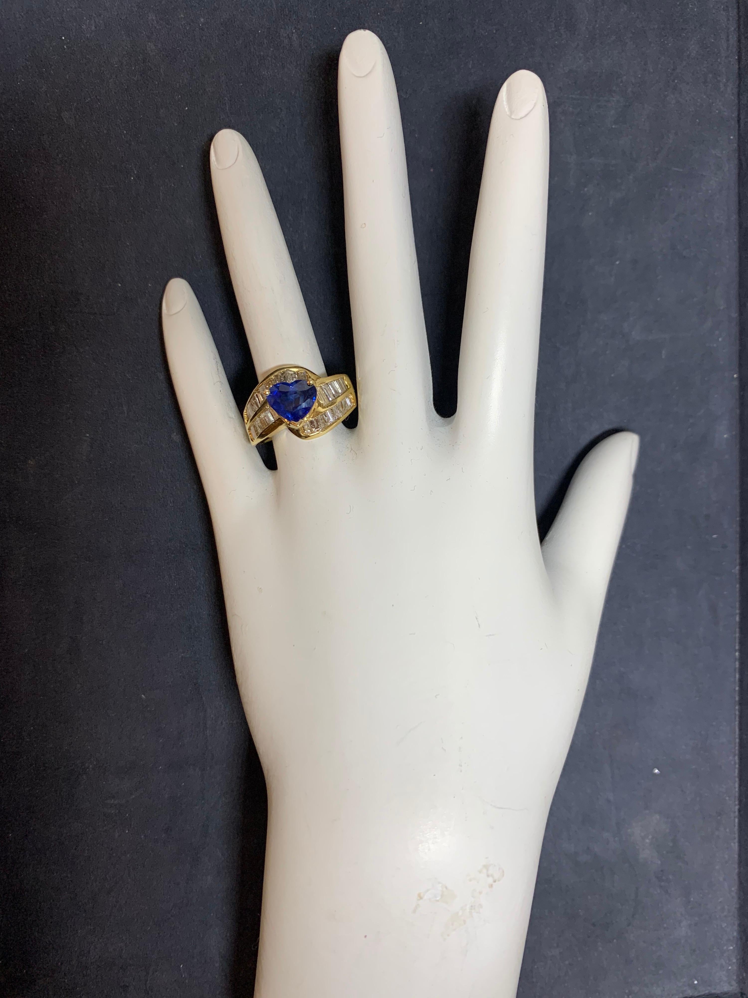 Retro 18k Yellow Gold Cocktail Ring.

Set with an approximately 2 Natural Heart Shape Sapphire (approximately 7.8x8.5x4.1mm) & approximately 2.50 carats of 36 natural Baguette Diamonds. 

Ring weighs 10.5 grams, size is 6.

Condition is Pre-owned.