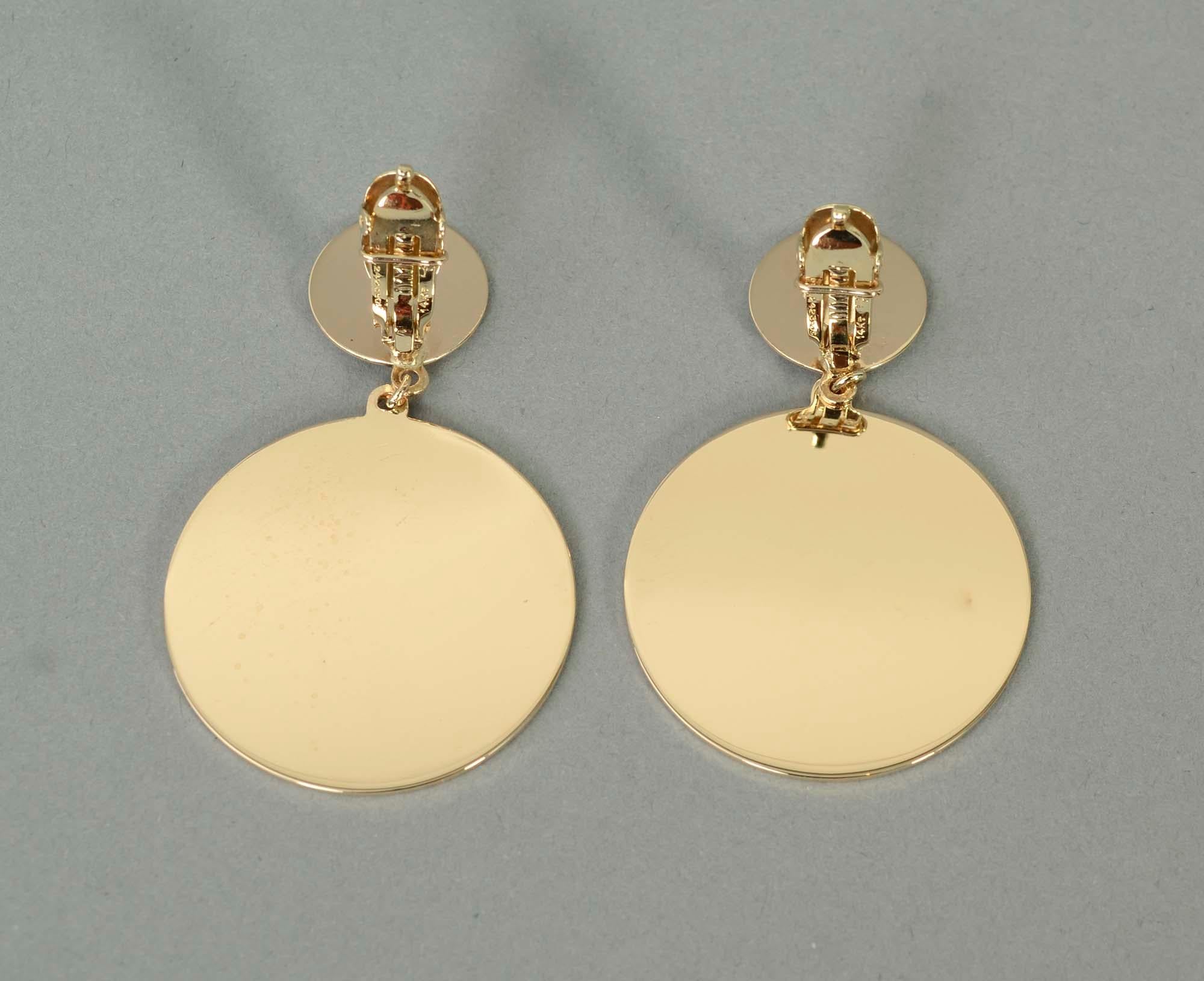 Dramatic Retro earrings of two circular discs. The top one measures half an inch in diameter; the bottom one is 1  5/16