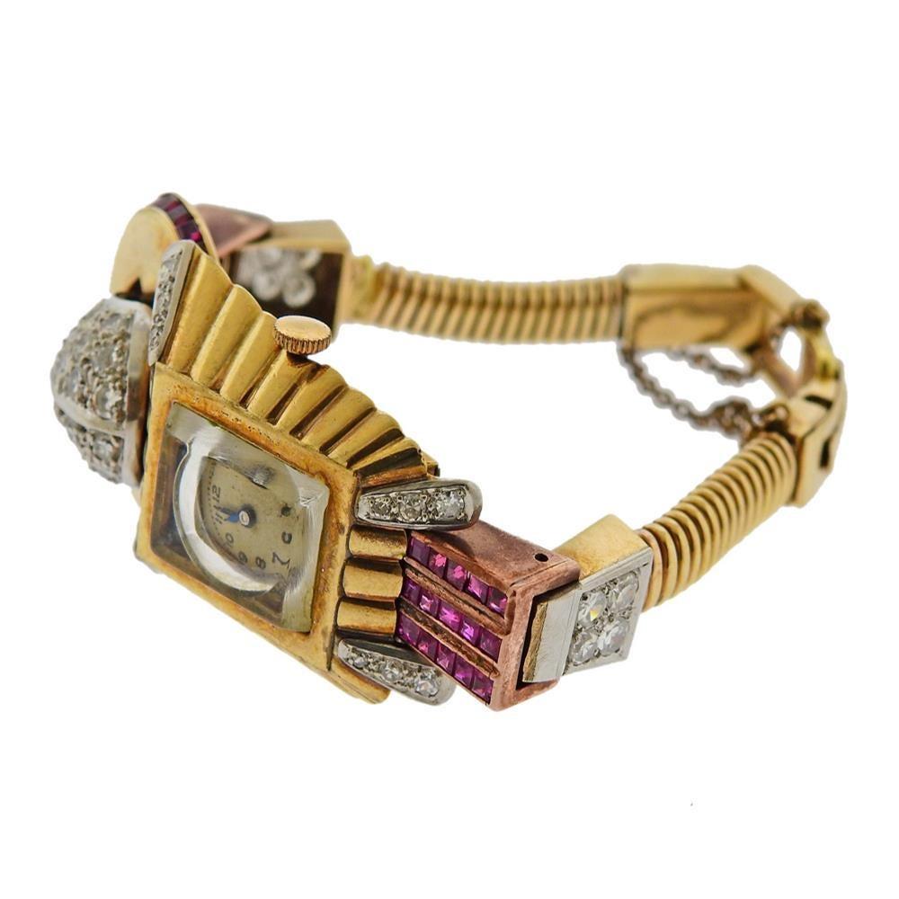 Retro mid-century 14k gold watch bracelet, set with rubies and approx. 1.60ctw in diamonds. Watch is manual wind, running order. Bracelet is 6.25