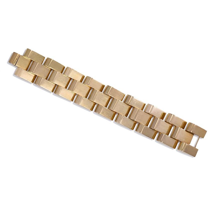 A chunky Retro gold escalator tank bracelet, each wedge-shaped component arranged in a brick link pattern, in 18k with French import mark.  94.9 dwt, 147.6 g