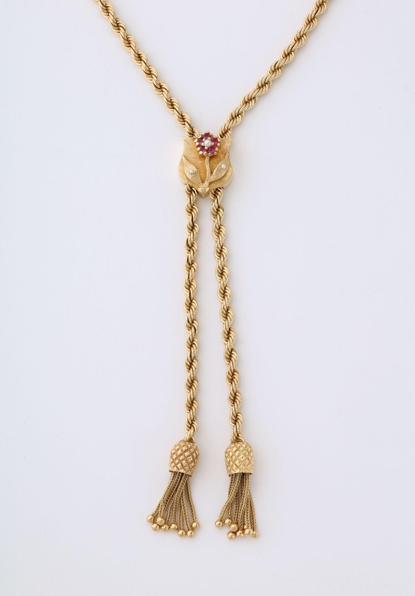 A Retro14k Gold Lariat on Rope Twist Chain with Pineapple Tassels and a Ruby and Pearl flower.  Measuring 22