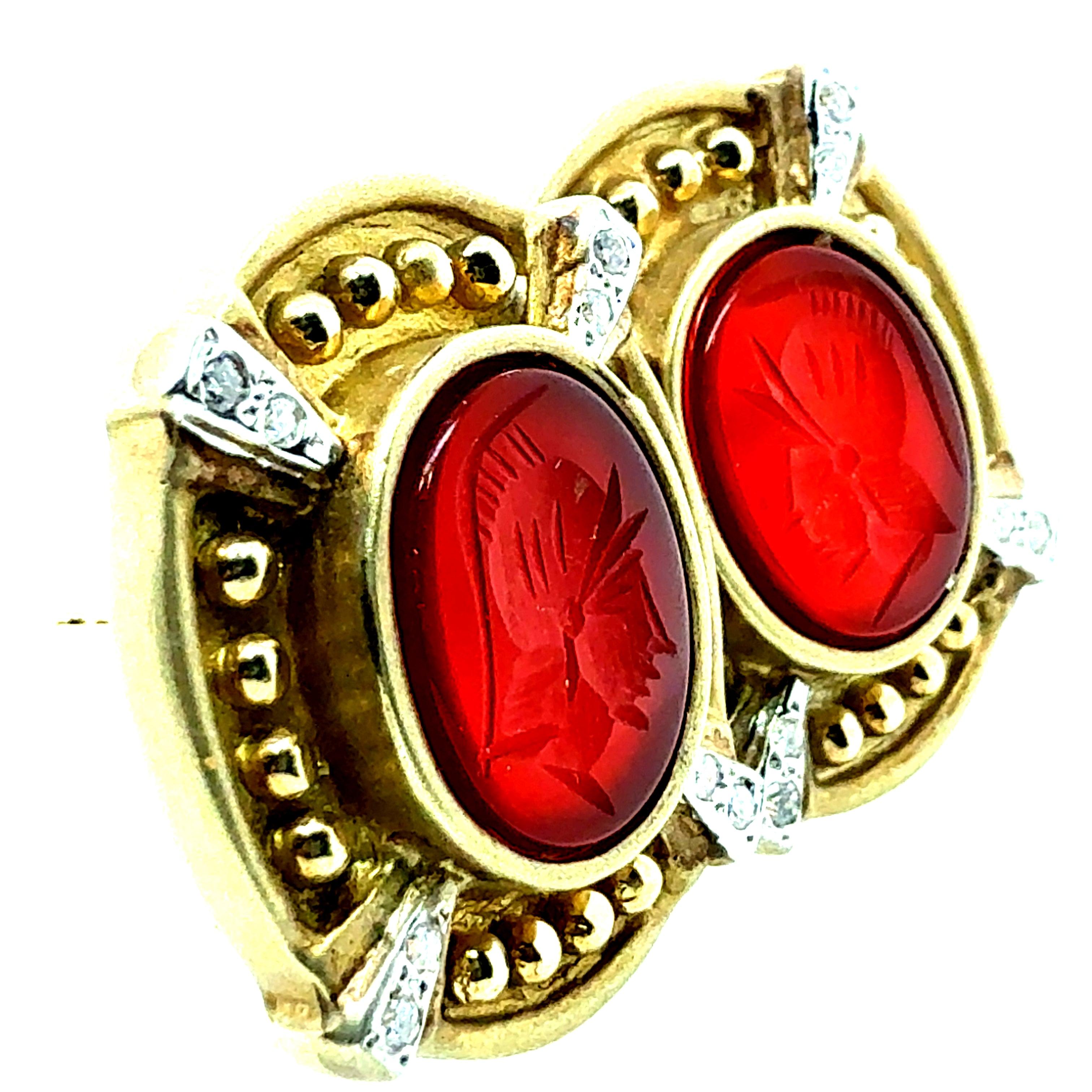 A magnificent pair of 14K brushed yellow gold earrings featuring natural diamonds and Roman carnelian intaglios. Each earring measures 22 mm in length and 19 mm in width and is set with natural round brilliant diamonds in white gold. The total