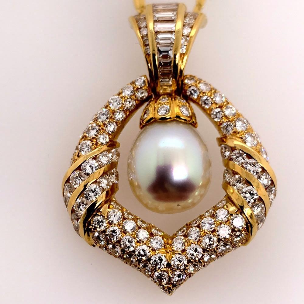 A Stunning Vintage Yellow Gold 7.5 carat (approximate) Natural Round Brilliant & Baguette Diamond Pendant. 

The bail (top portion) has a hinge allowing it to slightly rotate back and forth, and can open up when the lock is released. It is set with