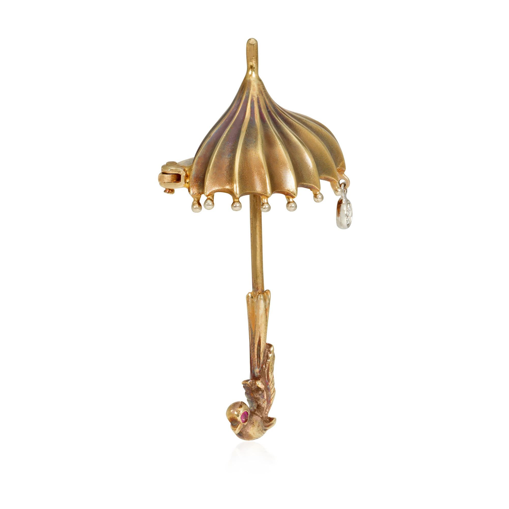 A whimsical Retro gold brooch designed as an umbrella with an articulated diamond raindrop and a handle in the shape of a bird with a ruby-set eye, in 14k.

* Includes free shipping
* Please do not hesitate to request additional photos or a video of