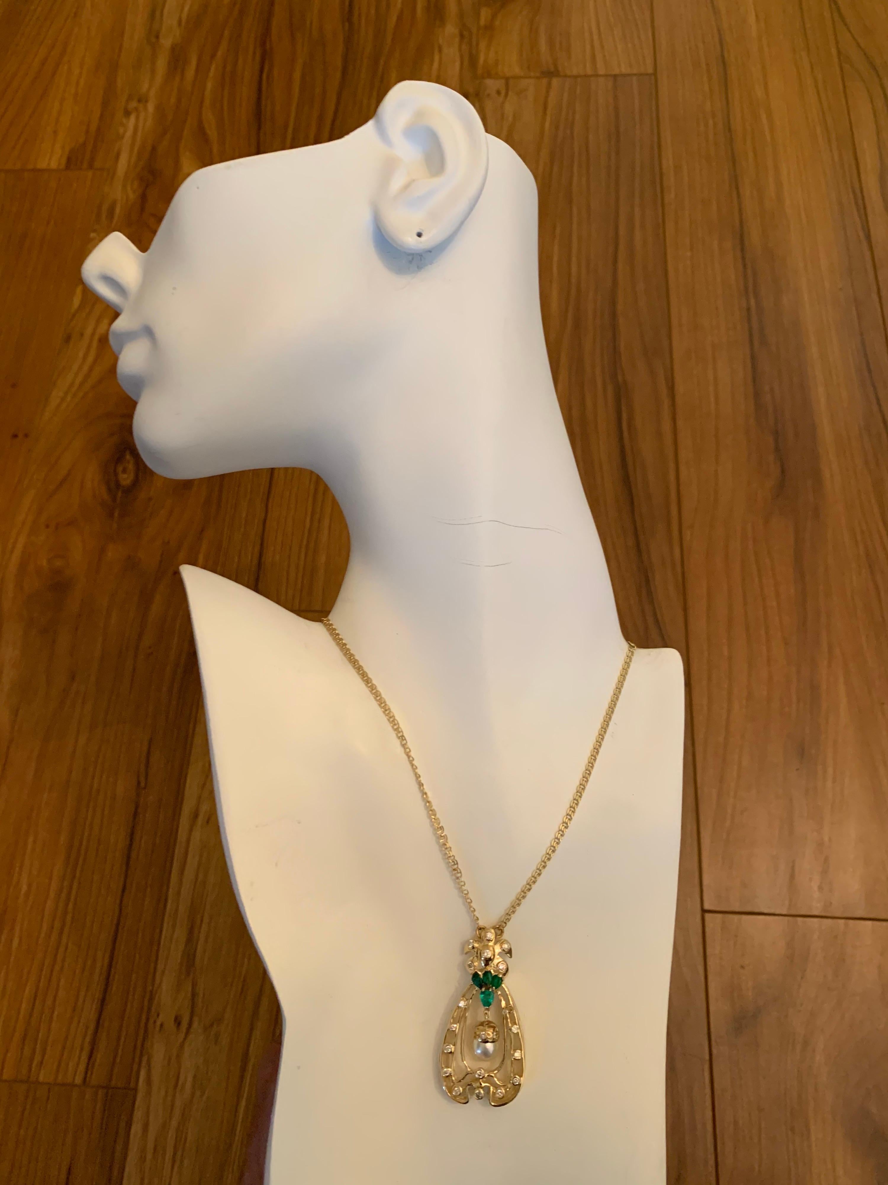 Retro 14k Yellow Gold Pendant 1.75 Carat (approx)  Natural Emerald & Diamond Circa 1960.

The piece itself weighs 19.7 grams and the attached chain is 16