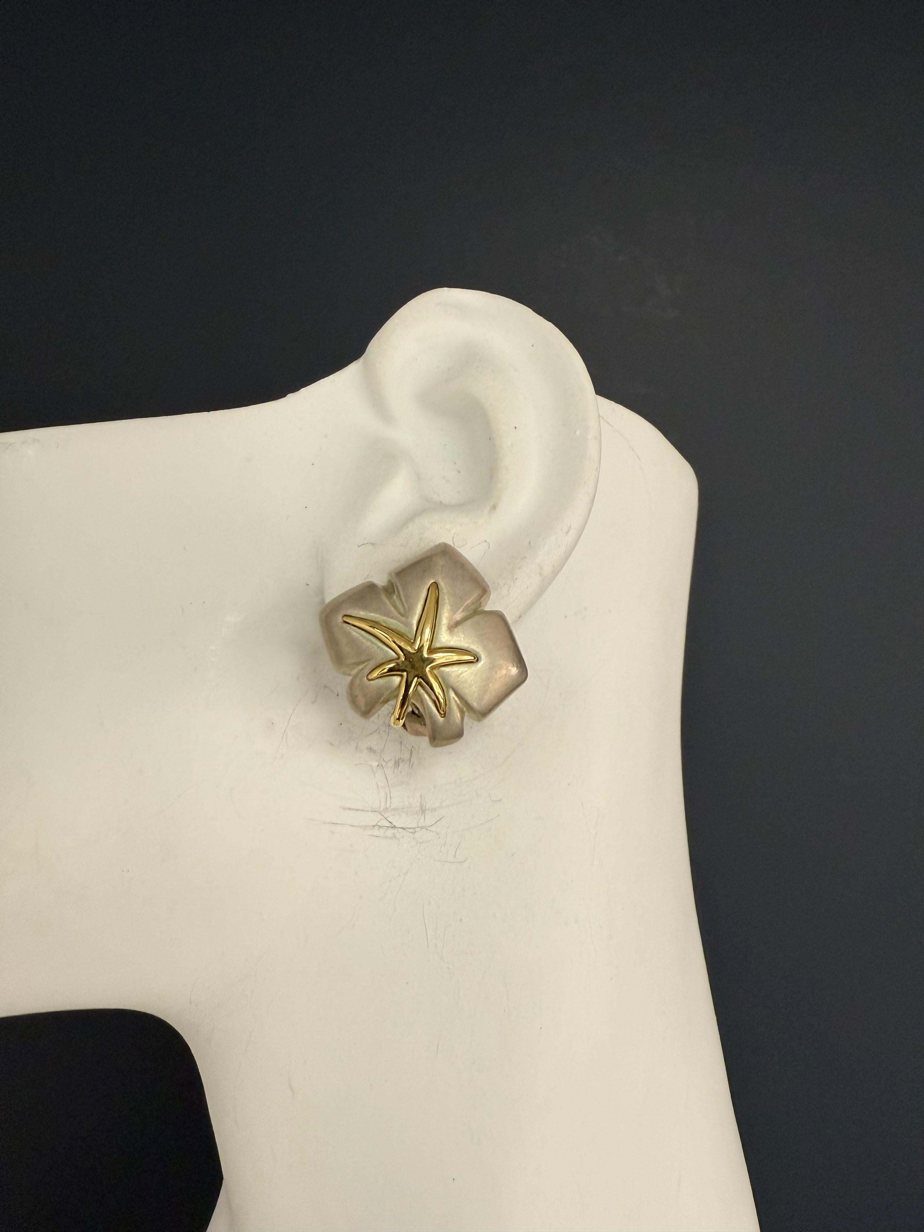 Retro starfish statement earrings by original Tiffany and Company, stamped 1991 Tiffany & Co. and 925. Crafted in sterling silver with gold detailing, the earrings measure approximately 25 mm in length, 25 mm in width, and 7 mm in thickness, with a