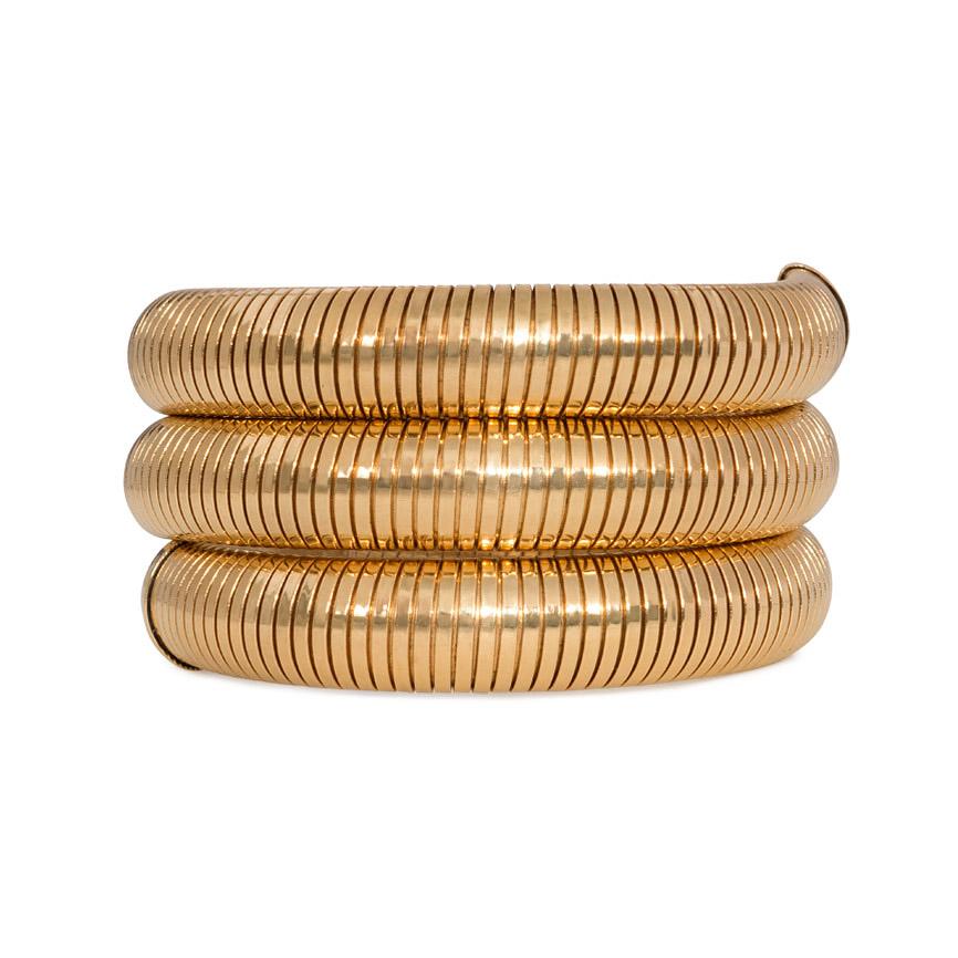 A Retro gold gaspipe / tubogas bracelet of flexible coiled design, in 14k.  Snug but comfortable fit, wearable in different positions for different looks