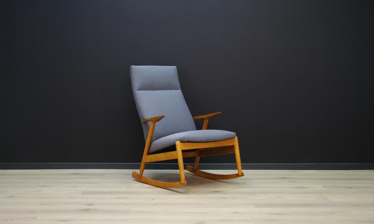 Sensational rocking chair, Danish design of the 1970s. A unique form, covered with a new fabric (color-gray), a construction made of ash wood. The armchair is in good condition (small dings and scratches) - directly for use.

Dimensions: Height 99