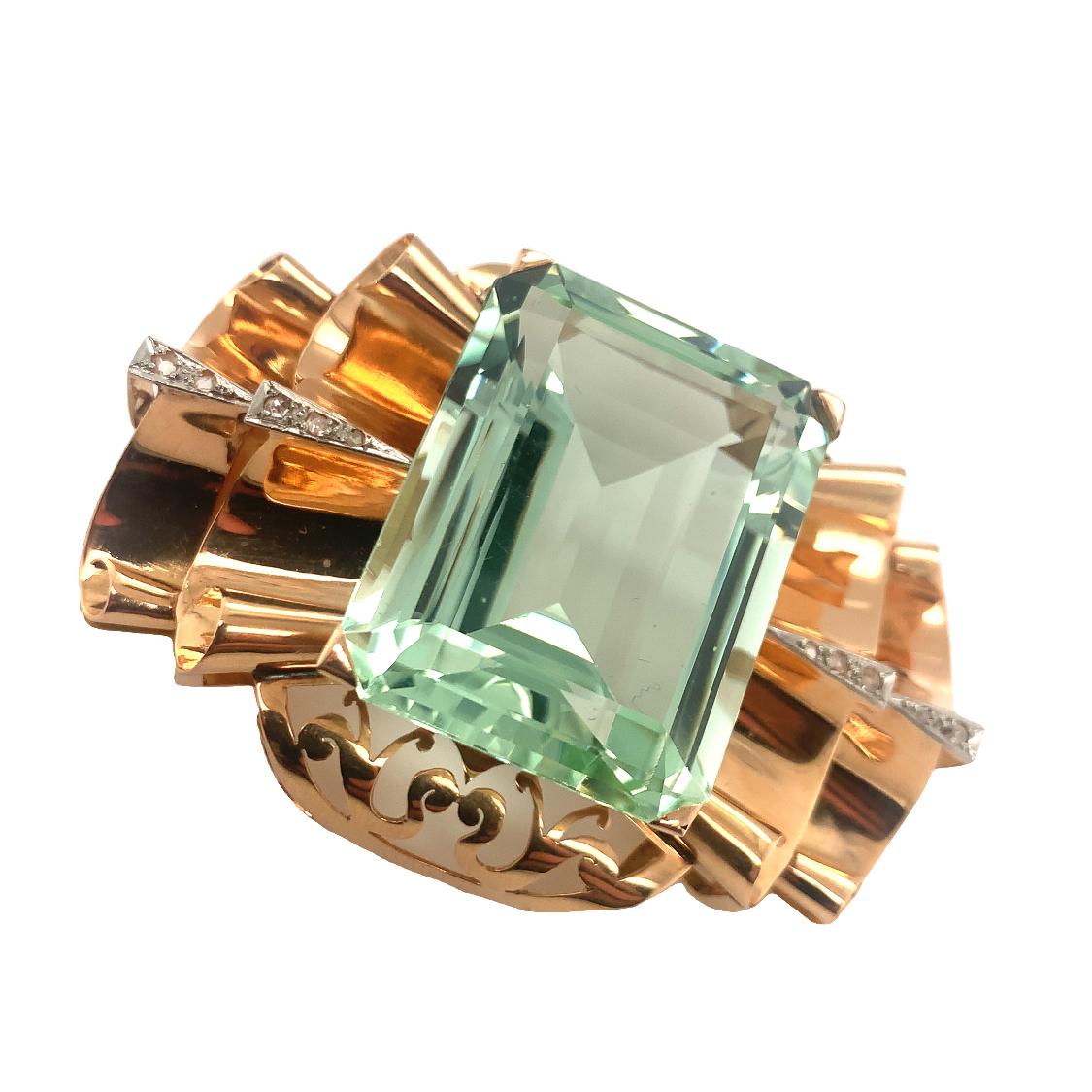 One green beryl and diamond 14K rose gold brooch featuring one impressive emerald step-cut green beryl weighing 90 ct. and 10 rose-cut diamond accents totaling 0.20 ct. Green beryl is aquamarine’s stunning sister gemstone, just in a different shade.