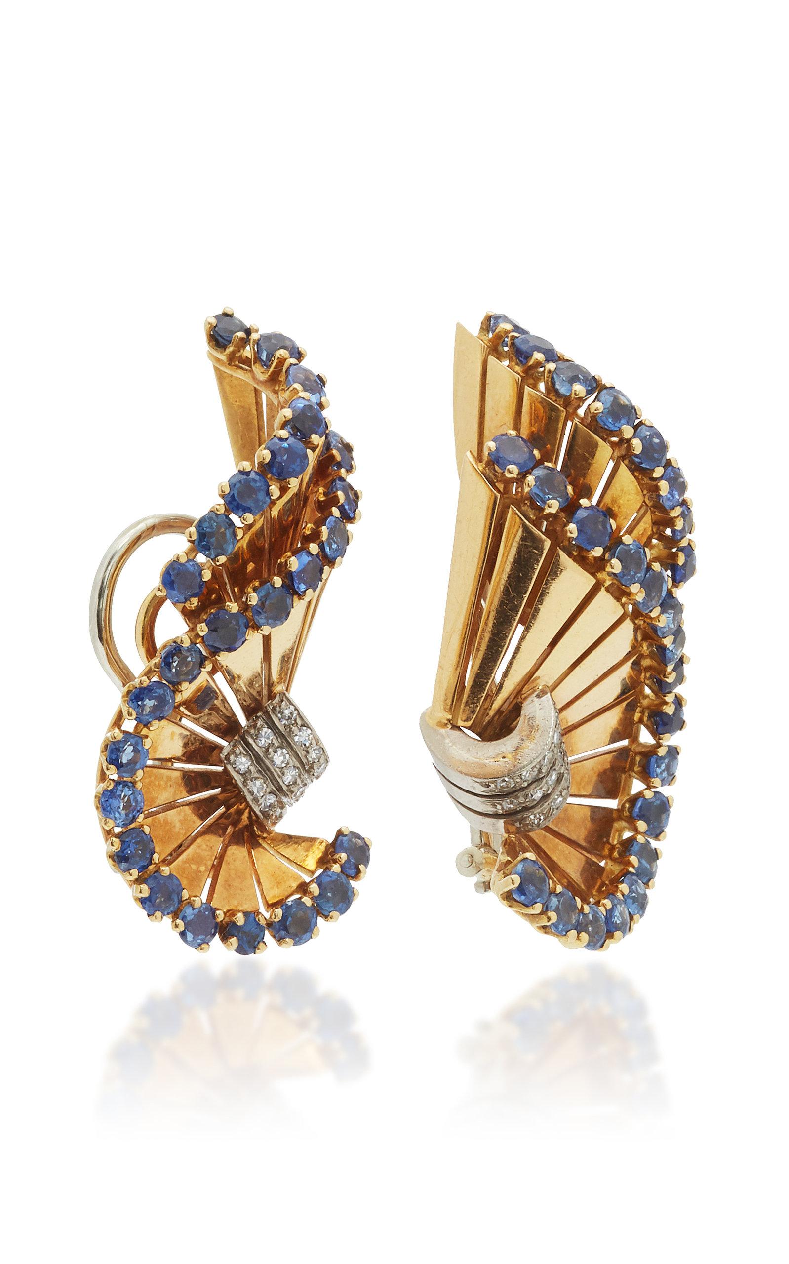 A pair of Retro 18kt yellow gold ear-clips of swirl design, embellished with sapphires and diamonds. By Gubelin, made in Switzerland, circa 1955.