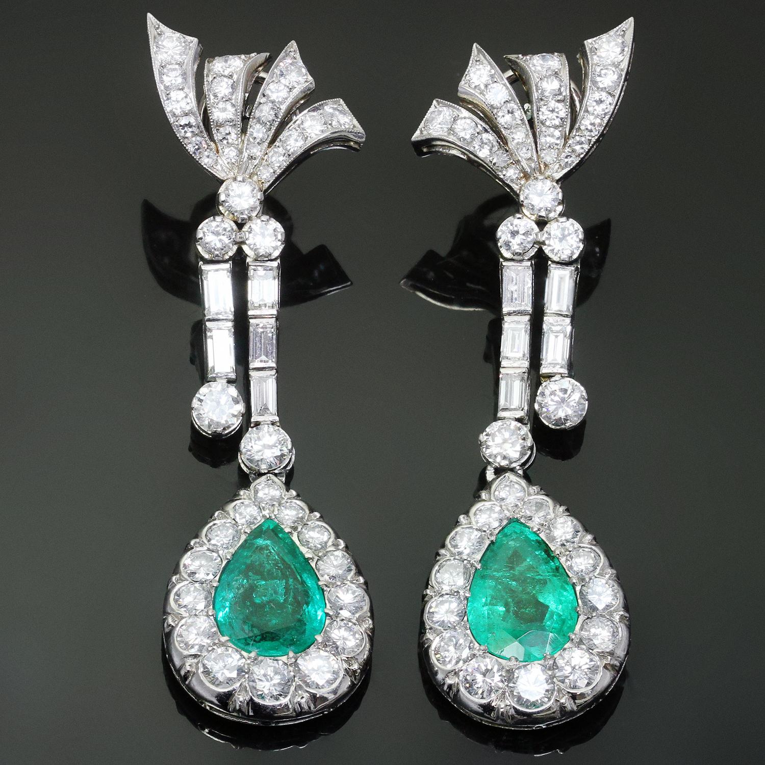 Elegant and captivating drop earrings hand-made in fine platinum. Each earring features a 8.0mm x 12.0mm pear-shaped faceted Colombian emerald stone  completed by 88 round diamonds and 10 rectangular diamonds of about 7.5 carats. These circa 1950s