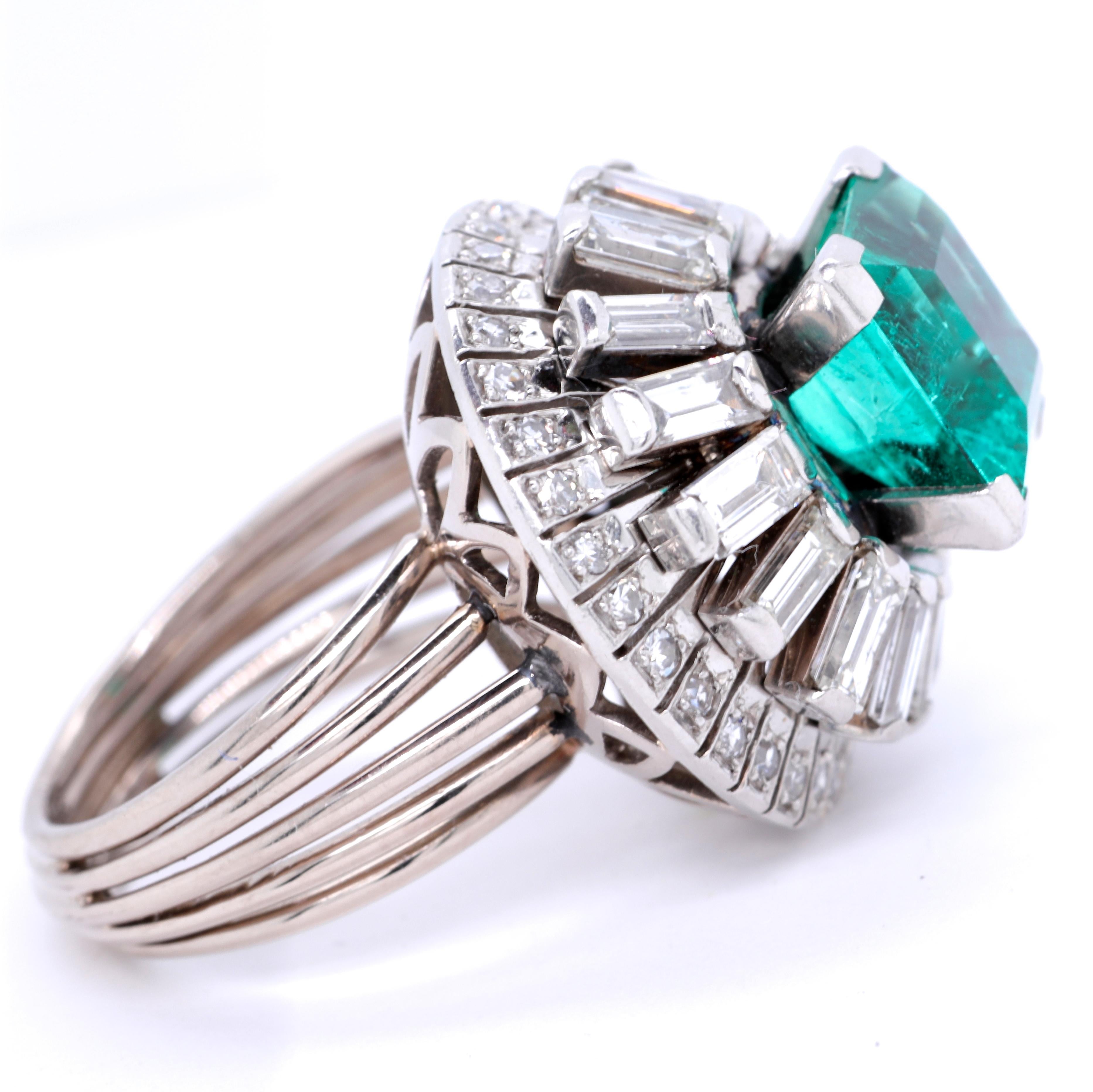 Make a statement as you walk into the room. This striking retro emerald and diamond ring will not let you go unnoticed at any soiree. Radiate your sparkle and confidence.  Henri Poincot Emerald Diamond Platinum Ring. AGL certified Columbian emerald