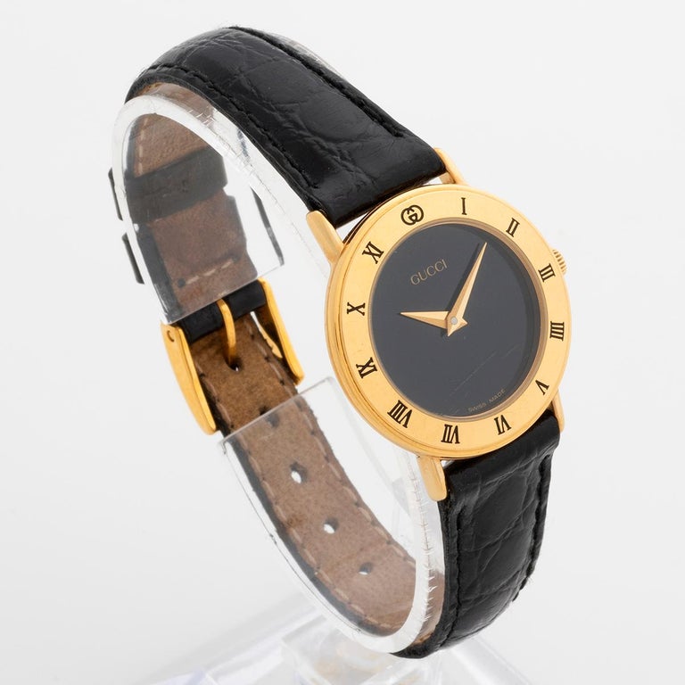 Our retro and iconic 1990s Gucci dress watch , reference 3000.2.L features a gold plated case and desirable black dial. An instantly recognisable dress watch, we date our Gucci 3000.2.L to circa 1990, and it is presented in good condition, with