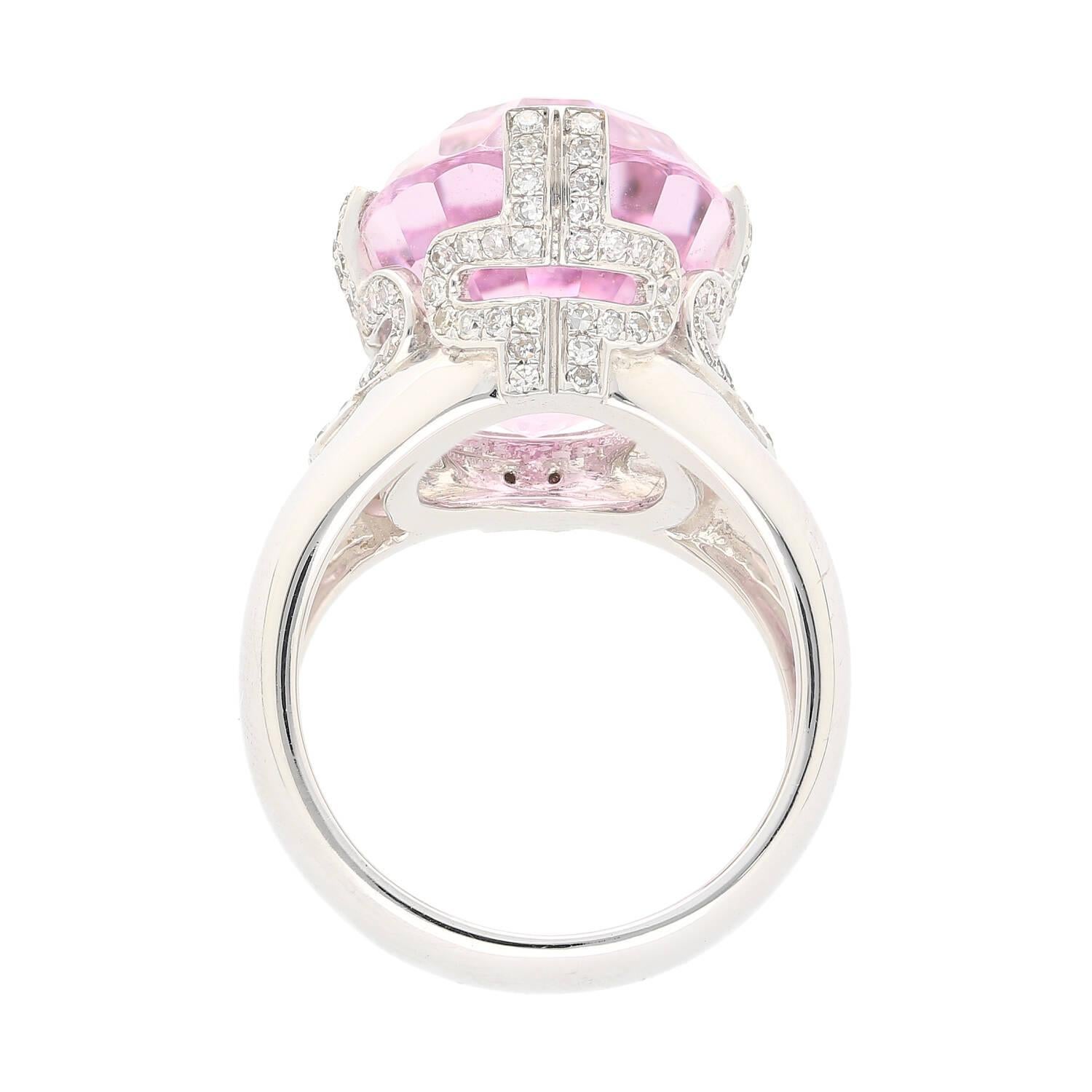 Shop this 20.76 carat oval cut pink Kunzite ring in 18K white gold with 0.66 carats diamond side-stones. This pink oval-cut Kunzite ring is a statement piece designed to capture the heart. Featuring 4 wide prongs that set the center stone with a