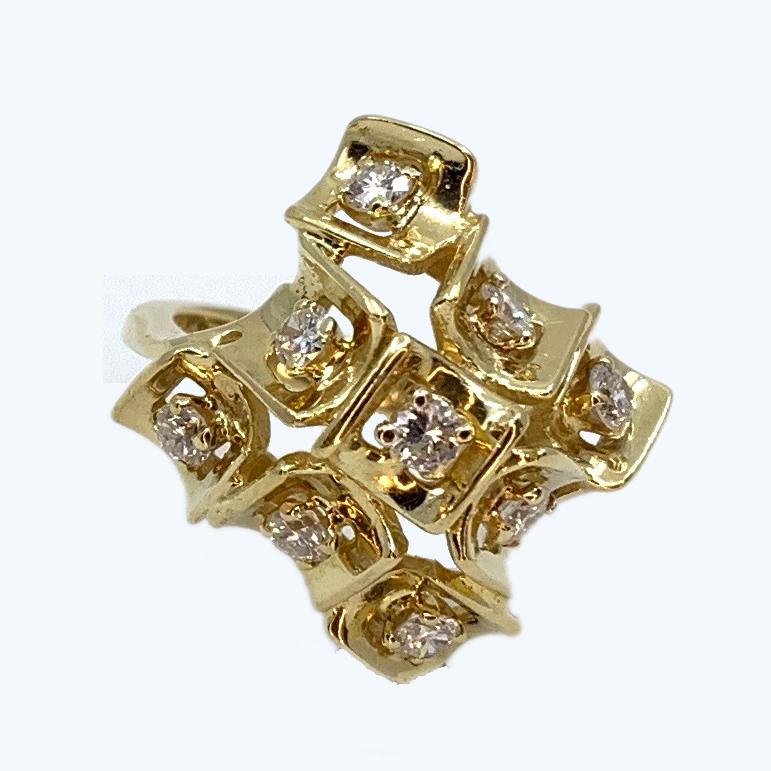 This interesting cocktail ring features a domed cluster of nine little gold squares, each curling around a 0.10 carat diamond.  The look is distinctly mid-century -- freeform in its elements yet with an overriding pattern --  and brings to mind