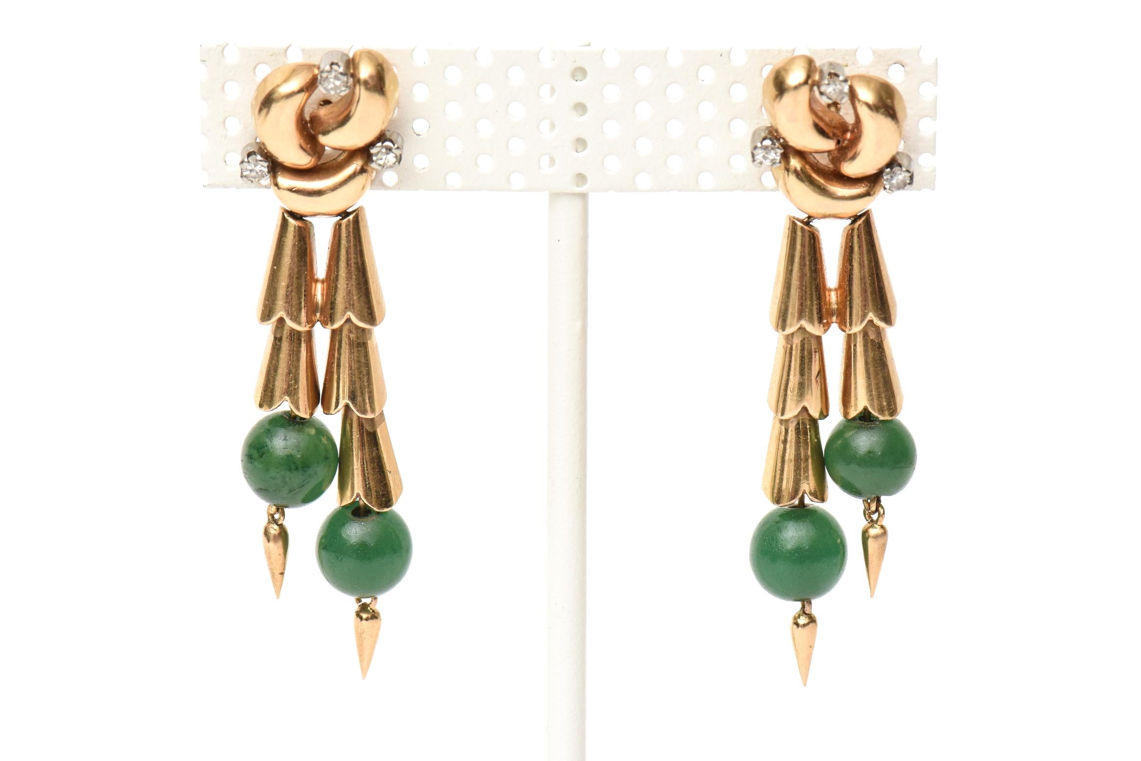 These stunning pair of retro 1940's style pair of pierced dangle earrings are have jade balls with 14K rose gold and tiny tiny diamonds. They are elegant and one is buying these for the retro look and style. They are very chic on and go dressy to