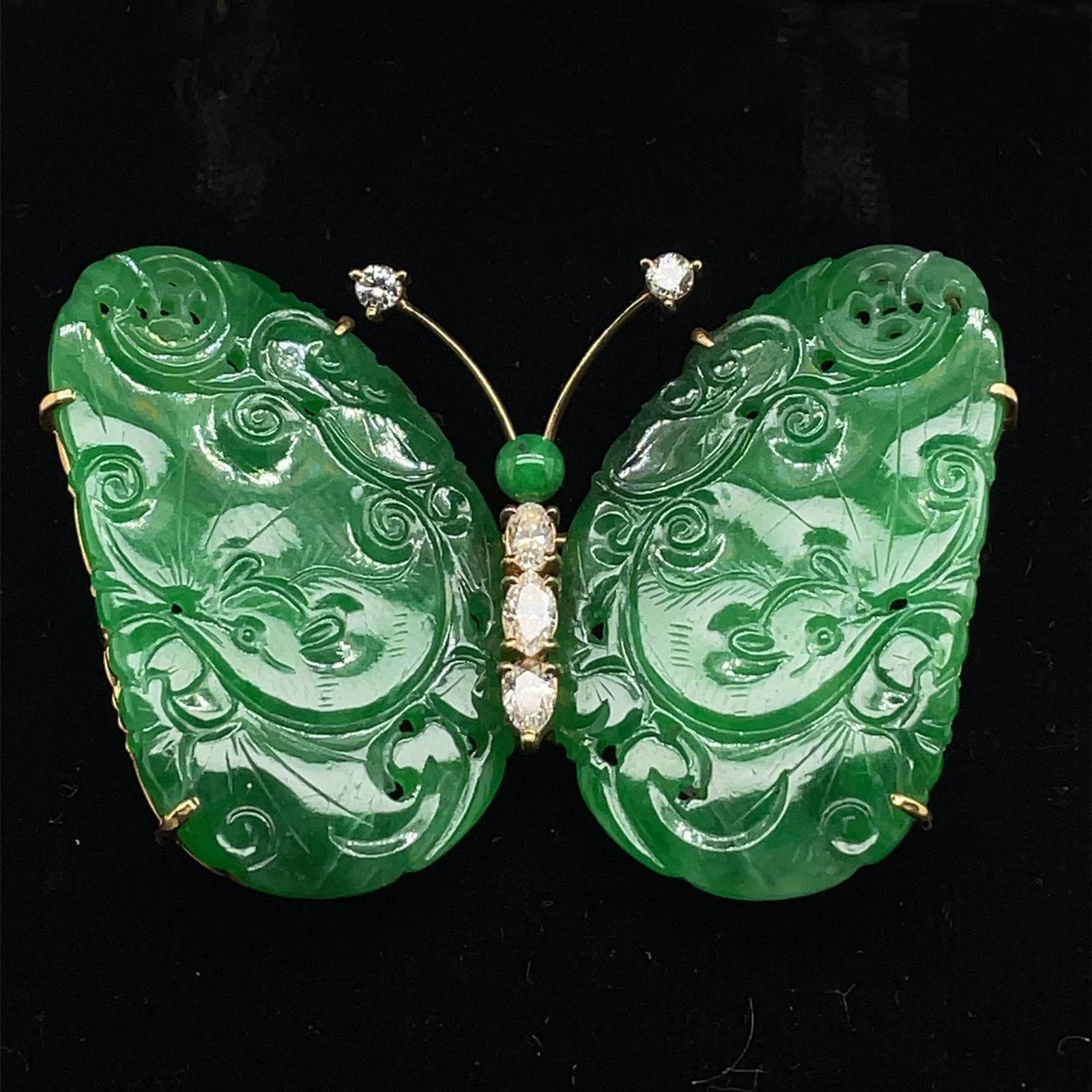 A retro natural untreated jade and diamond butterfly brooch, circa 1960.

This fun and vibrant brooch features two intricately carved wings of natural untreated 'imperial green coloured' jadeite set either side of the butterfly's diamond body,