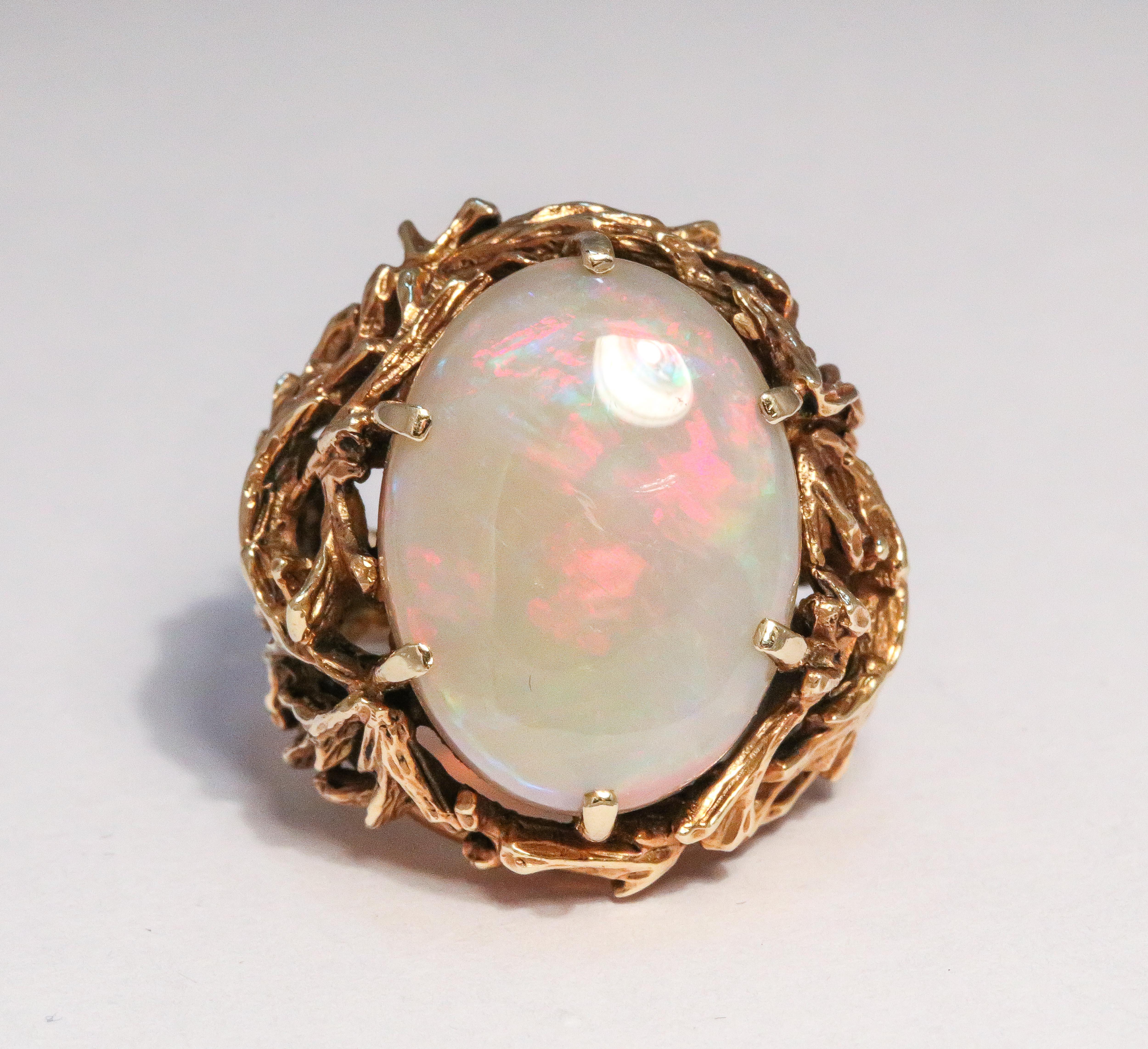 Large Ladies Cocktail white opal gold ring, with gold foliate work

total weight is 15 grams
14k Gold
White Opal is 20x15.5x8mm Oval Cabochon with Green Blue & Red Flashes
Approx. 14cts