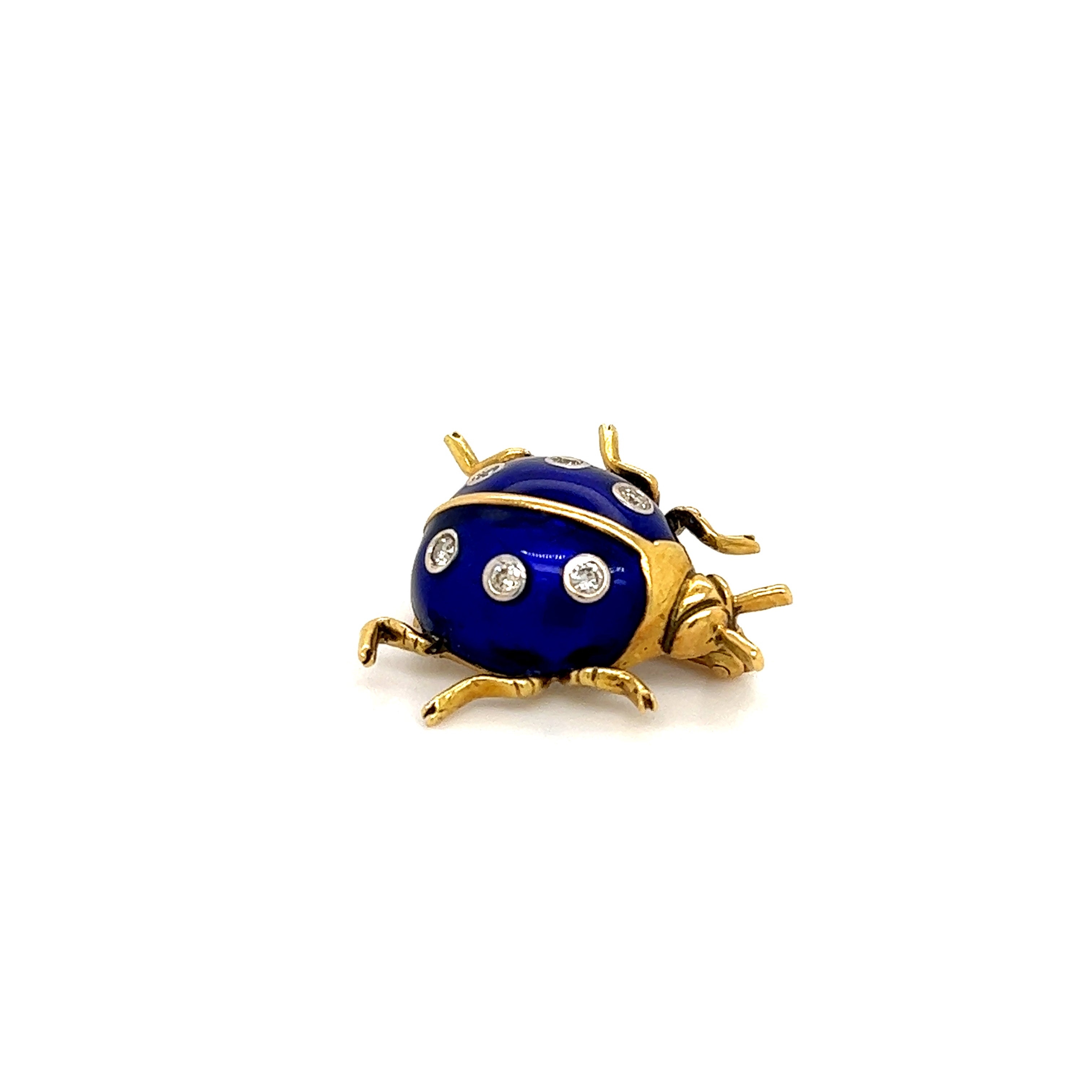 Beautifully crafted ladybug brooch in 18k yellow gold. The ladybug shows details throughout as it is highlighted with an electric colored cobalt blue enamel. Nestled within the enamel are six round brilliant cut diamonds. They add the perfect touch