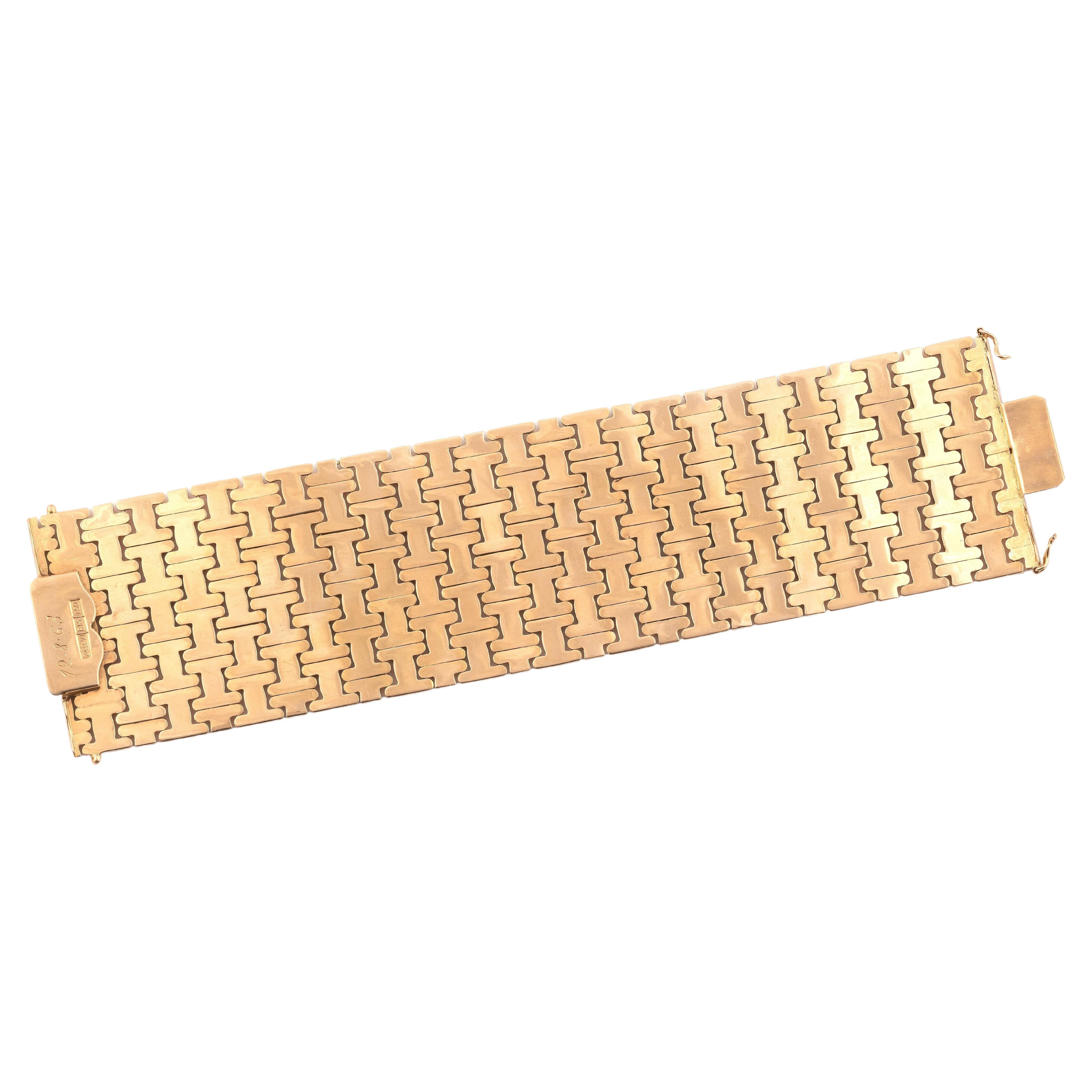 Un bracelet vintage en or 18ct large conçu comme une série de panneaux géométriques, mesurant approximativement 20cm x 5cm, fait en or jaune, vers 1960, poinçonné or 18ct, italien, poids brut 97 grammes.

Ce bracelet vintage est en excellent état.