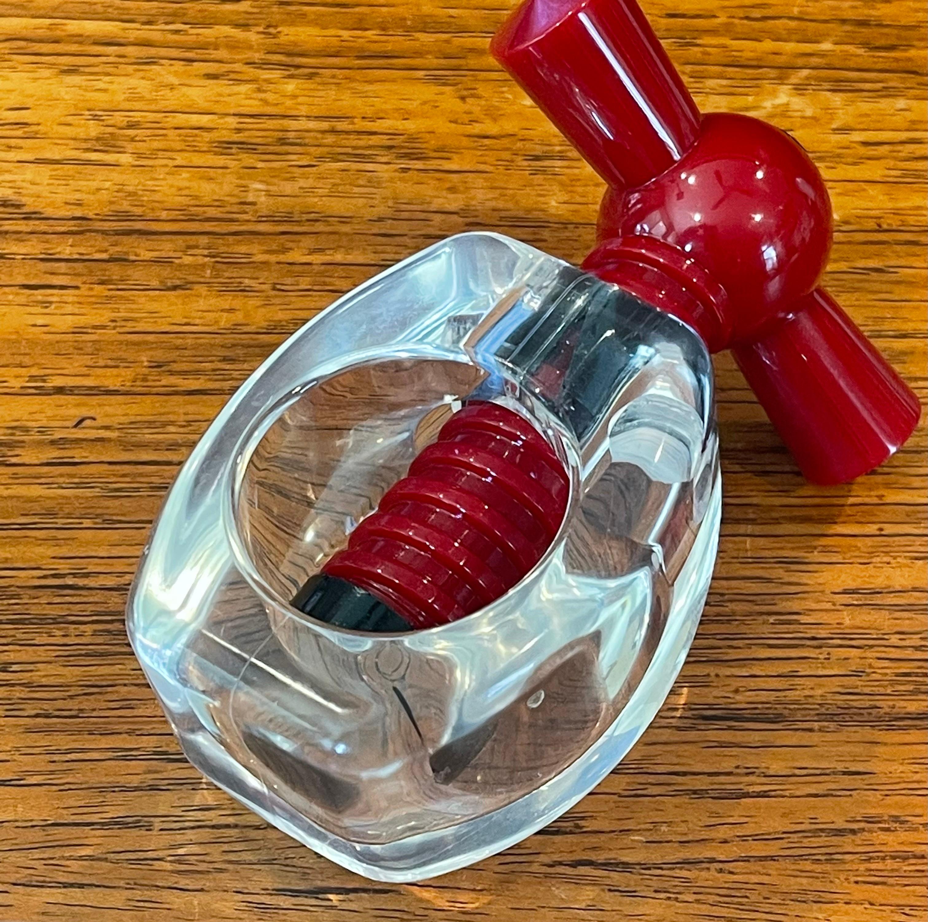 A funky and retro luite nutcracker, circa 1970s.  Chunky tactile transparent body with red twist mechanism. Formed quality acrylic, made by Imp Ltd, High Wycombe, England.  The piece is in very good vintage condition and measures 3