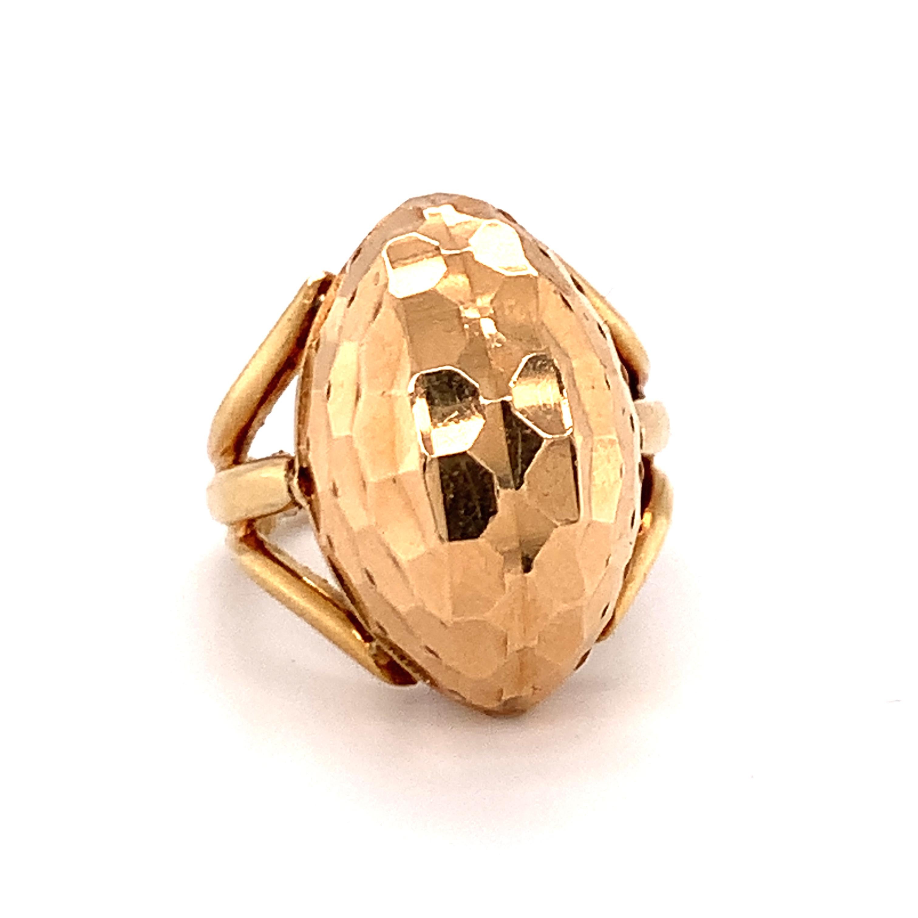 One Retro marquise-shaped hammered 18K rose gold ring with incredible dimension and sheen measuring 24 x 15 millimeters in size across the top portion and 13 millimeters high when worn upon the finger. The ring features open work shoulders split