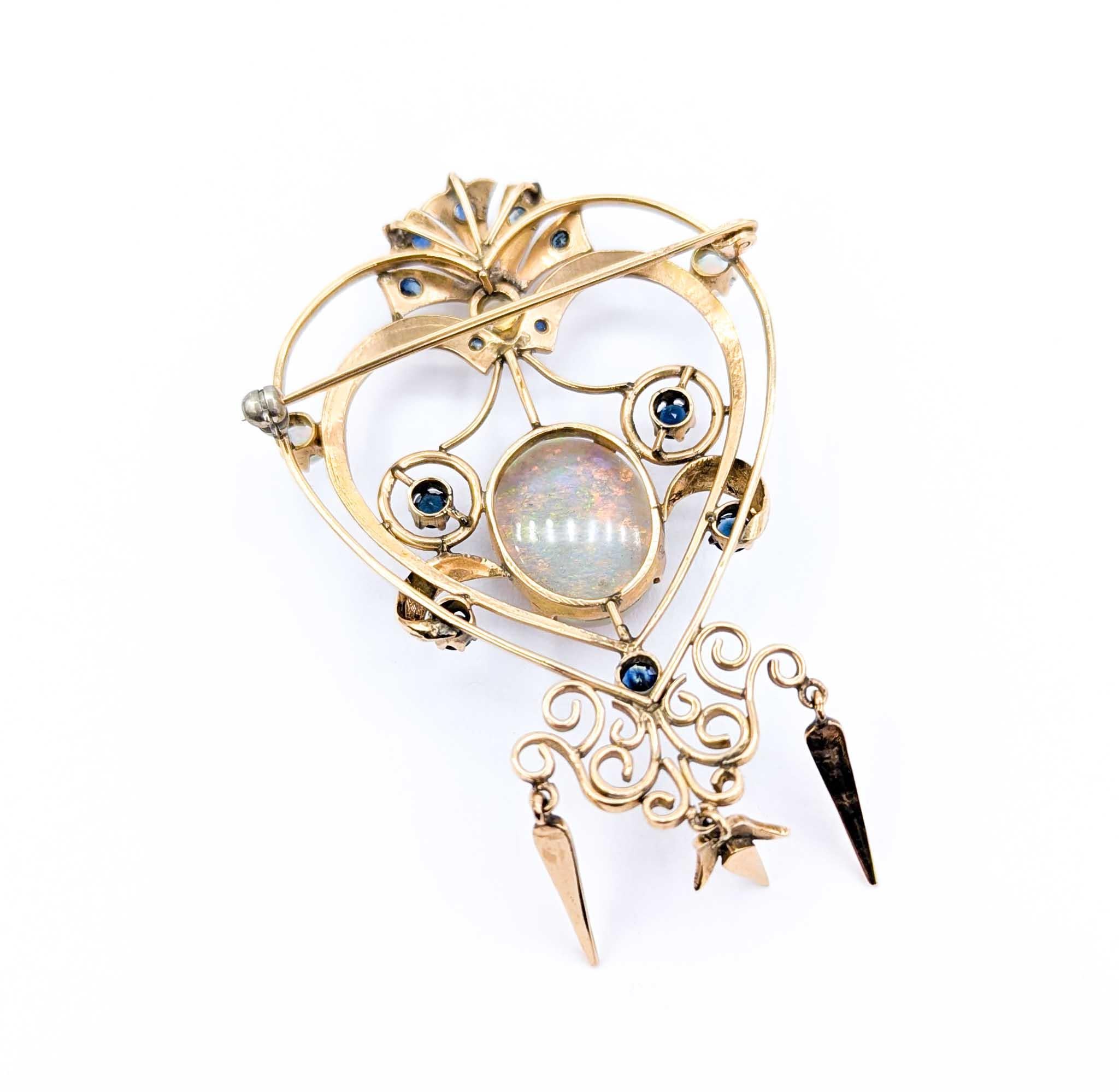 Retro Mid-Century 7.50ct Opal & Sapphire Brooch in Yellow Gold
Introducing this beautiful vintage opal Brooch, meticulously crafted in 14k yellow gold. This stunning piece showcases a 7.50ct Opal, further accented with 1.00ctw in deep blue