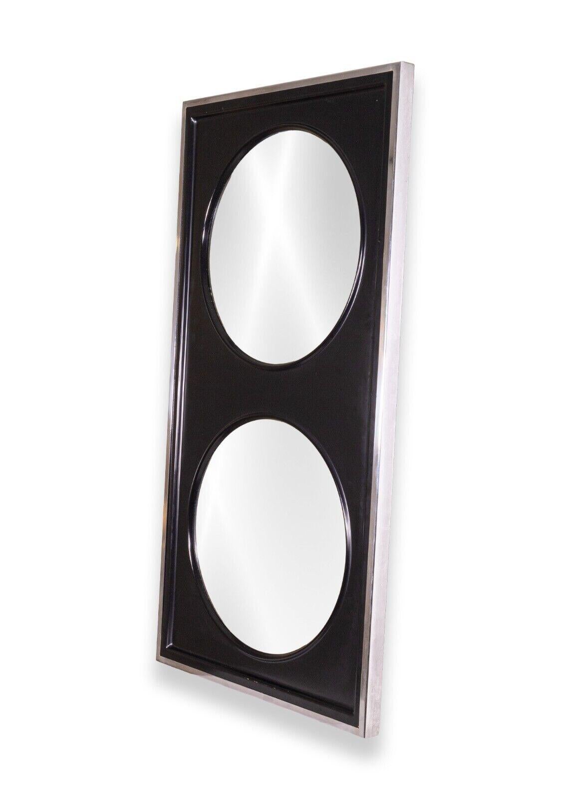 A retro mod heavy custom dual mirror made in Canada. This wonderful retro mod mirror features a chrome metal frame, a matte black face with raised bevels, and a dual mirror design. This piece is wired to be hung horizontally, but could be rearranged