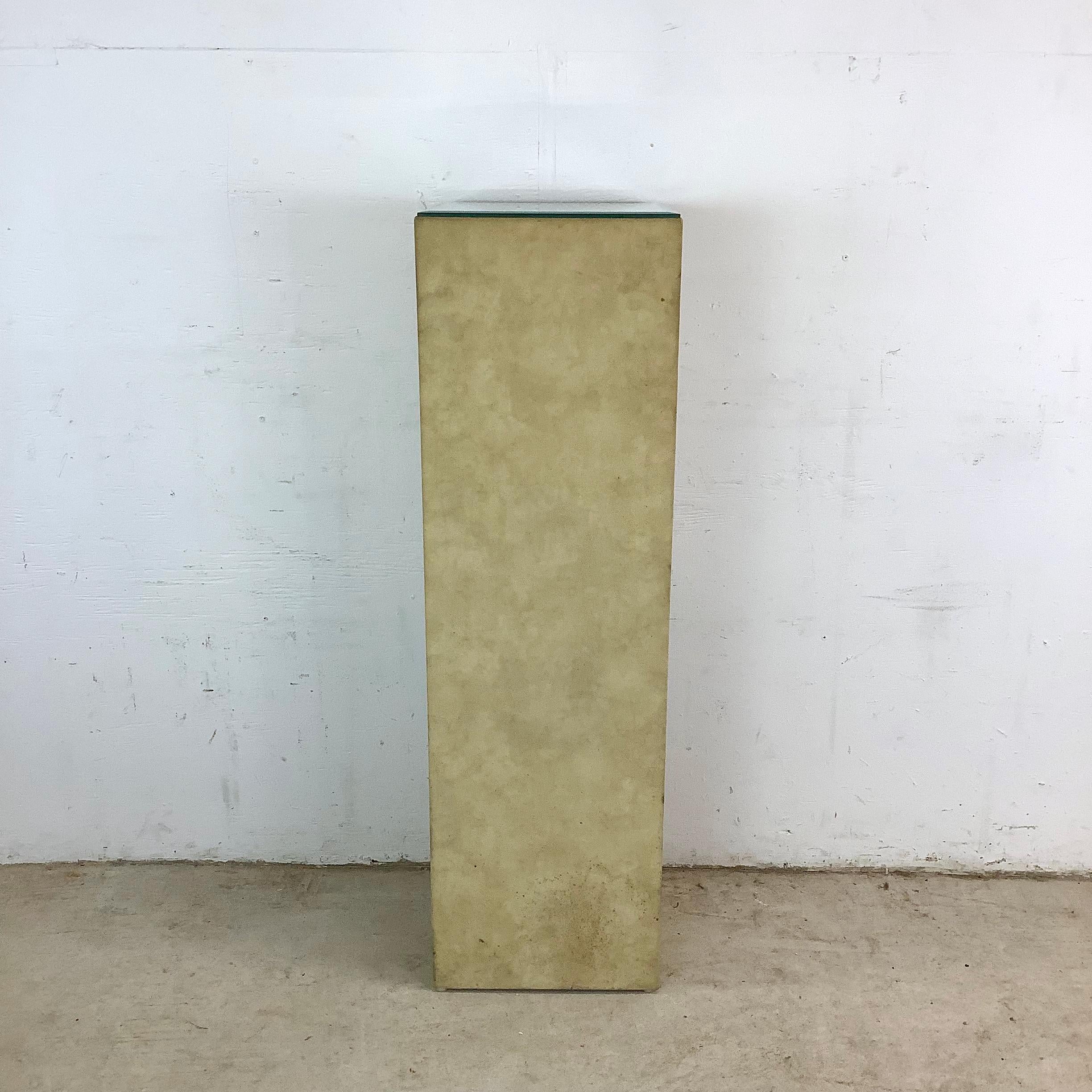 This vintage micro suede pedestal pairs soft texture with sleek reflection, creating a refined platform for your favorite decorative pieces. The body is wrapped in a gently mottled faux suede, complemented by a beveled mirror top that adds crisp