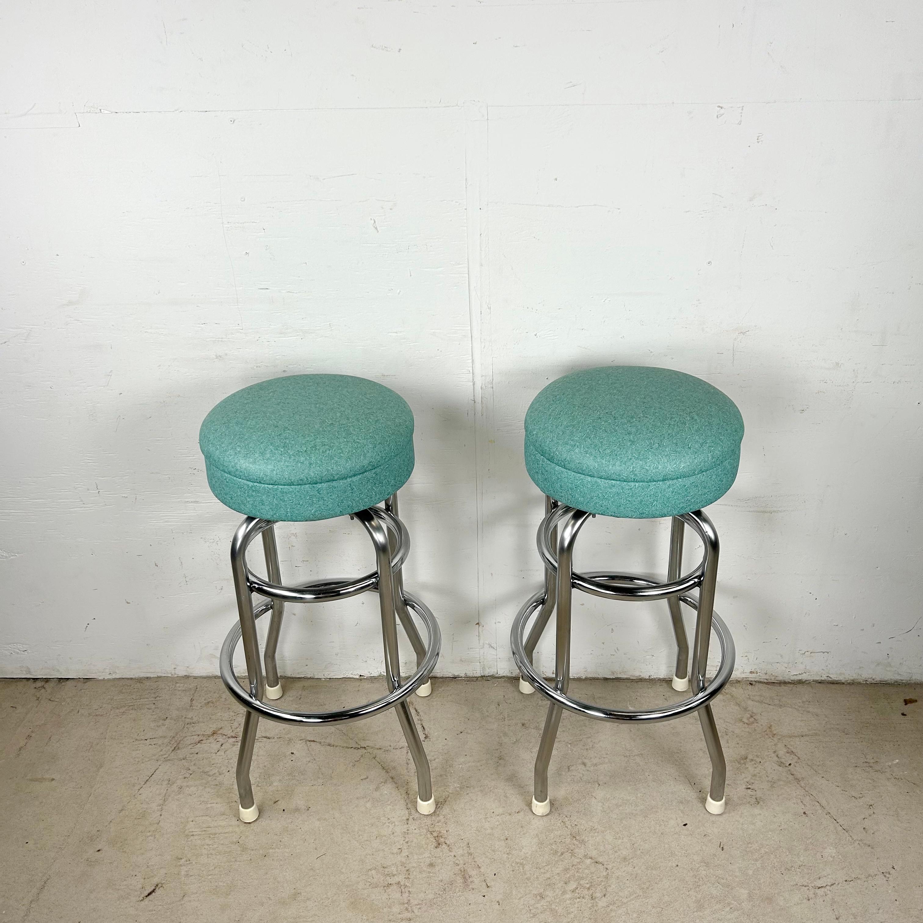 This set of six vintage bar stools captures the playful spirit of 1960s design with a bold splash of aqua color and sleek tubular steel frames. Each stool is topped with a padded vinyl seat that swivels for comfort and convenience, making them as