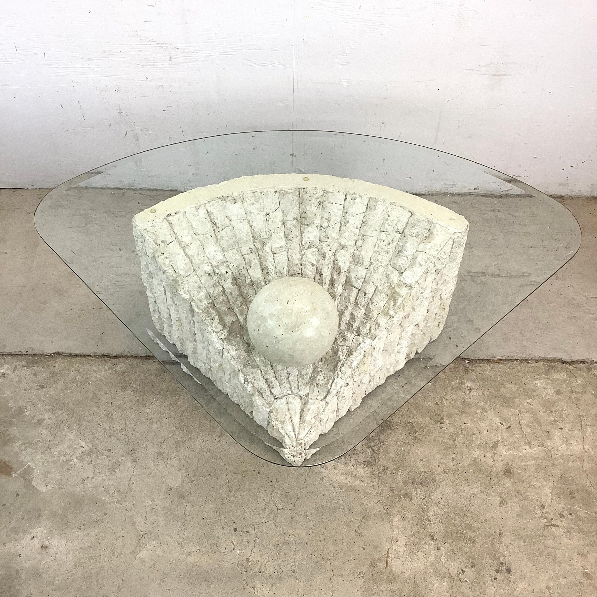This vintage 1980s coffee table is a sculptural showpiece that embodies the elegance and bold experimentation of postmodern design. Its base, a solid wedge-shaped pedestal crafted from tessellated stone, features natural stone fragments meticulously