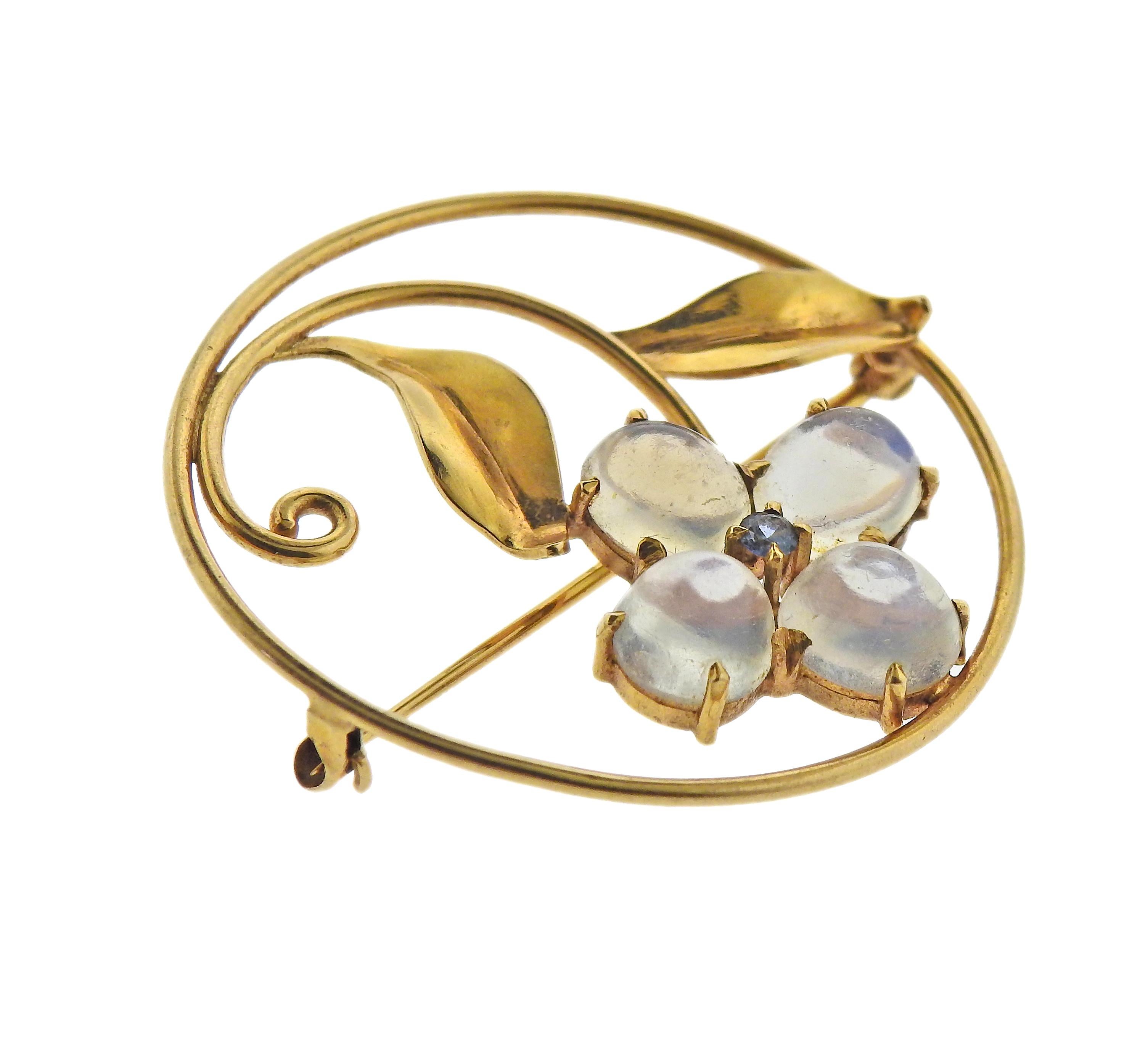 Classic Retro 14k gold circle brooch, depicting a flower, set with 4 moonstone cabochons and a blue gemstone. Brooch is 37mm in diameter. Marked 14k. Weight - 7.3 grams.