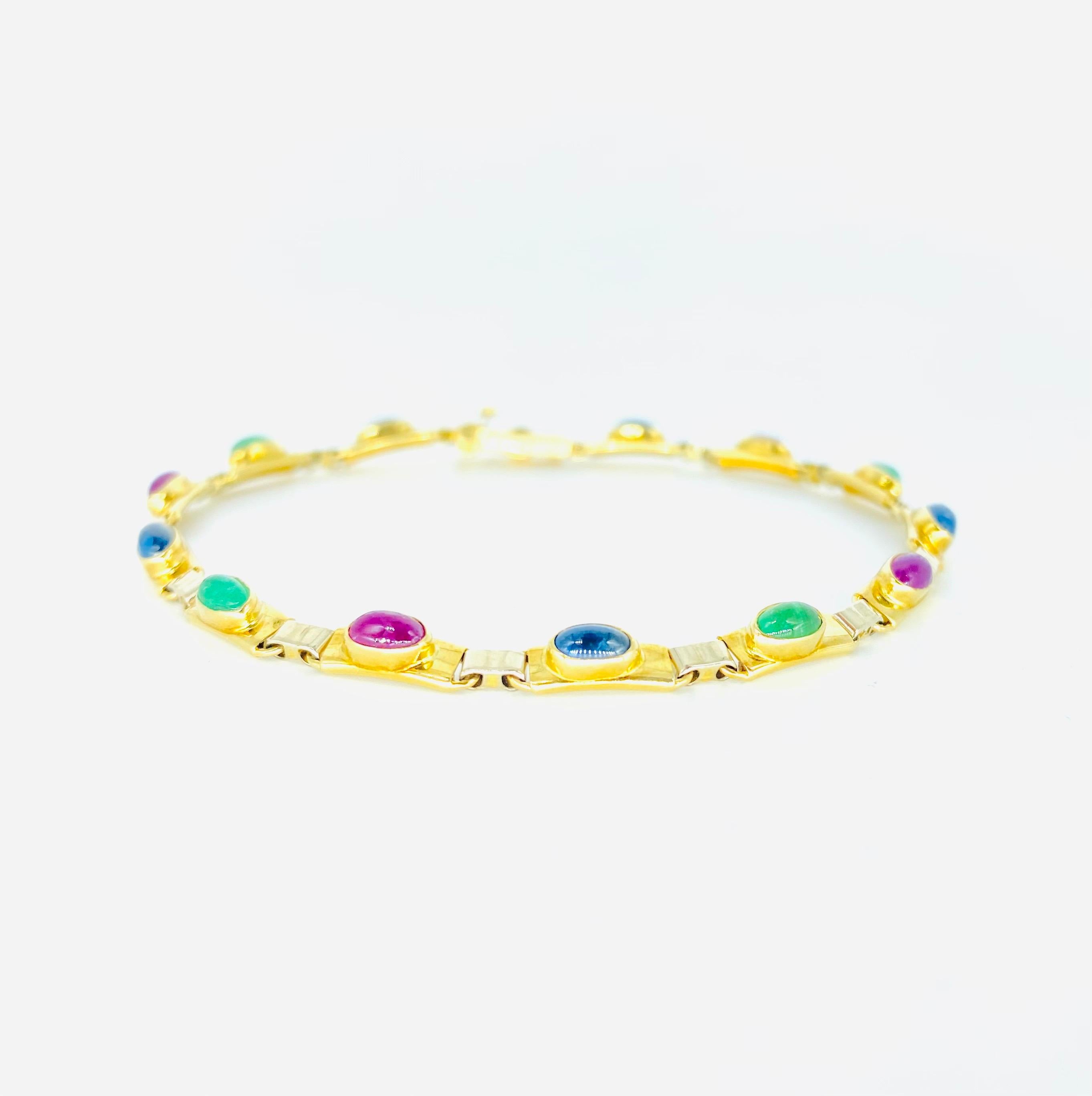 Retro Multi-Color Oval Cabochon Emerald, Ruby & Sapphire Tennis Bracelet. Beautiful bracelet featuring precious cabochon cut gemstones all around crafted in 14k yellow gold and white gold. There is also a secure closure lock for extra security. The