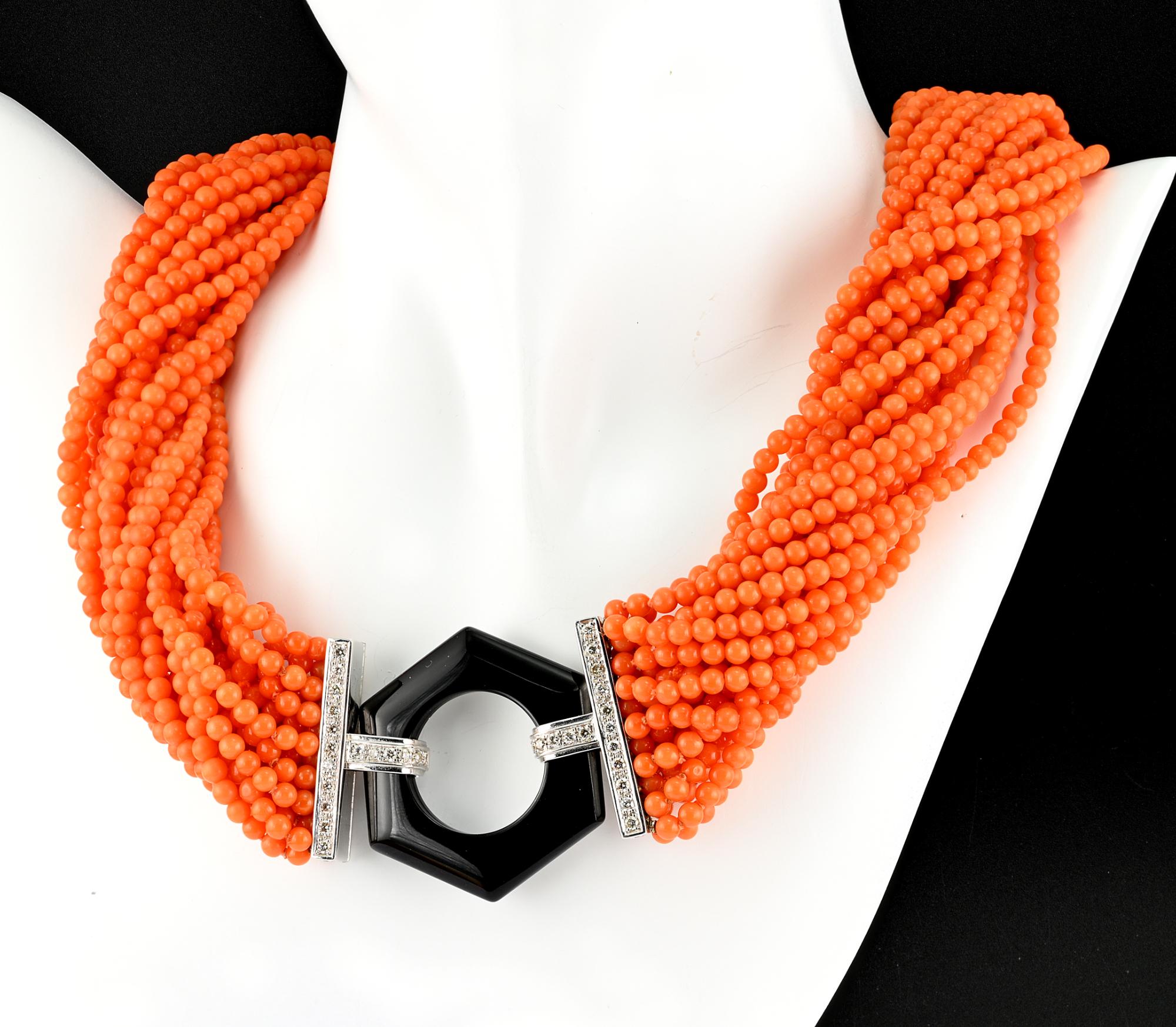 This marvelous mid – century retro multi-strand torsade necklace is Italian origin, 1945 ca.
Comprising 21 strands of Salmon Orange natural Coral beads of 4 mm. average size
Completed with a large clasp made by an hexagonal hand carved black Onyx