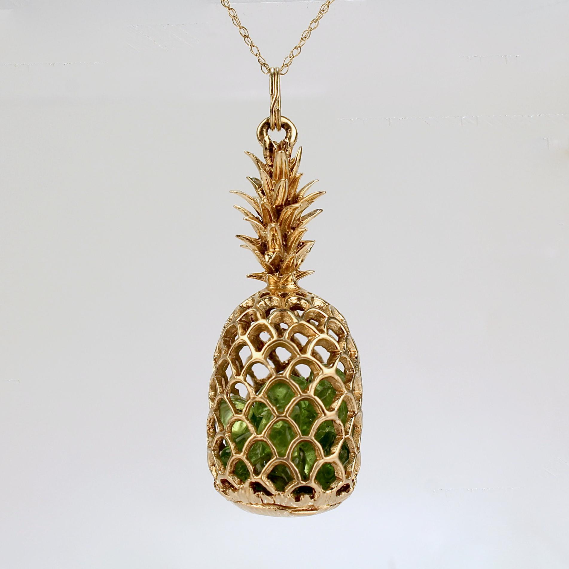 A very fine NaHoku gold and emerald pineapple pendant.

With more than 2 dozen smooth uncut emeralds encased in a 14k gold pineapple pendant.

The pineapple functions as a locket with a closure that opens and closes on the bottom of the