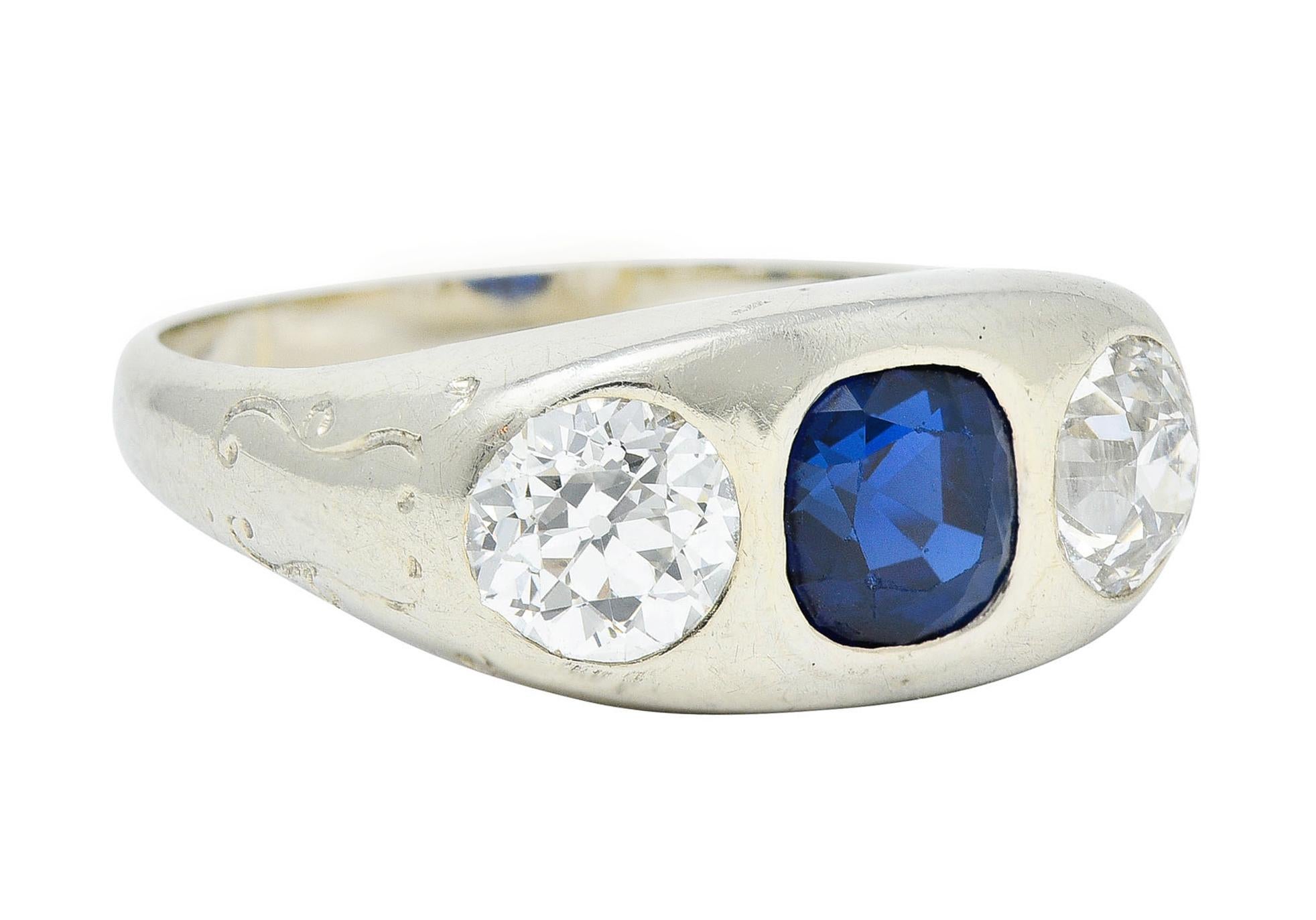 Gypsy style ring centers a cushion cut Cambodian sapphire

Weighing approximately 1.40 carats - medium dark royal blue with no indications of heat

Flanked by two flush set old European cut diamonds

Weighing in total approximately 1.65 carats with