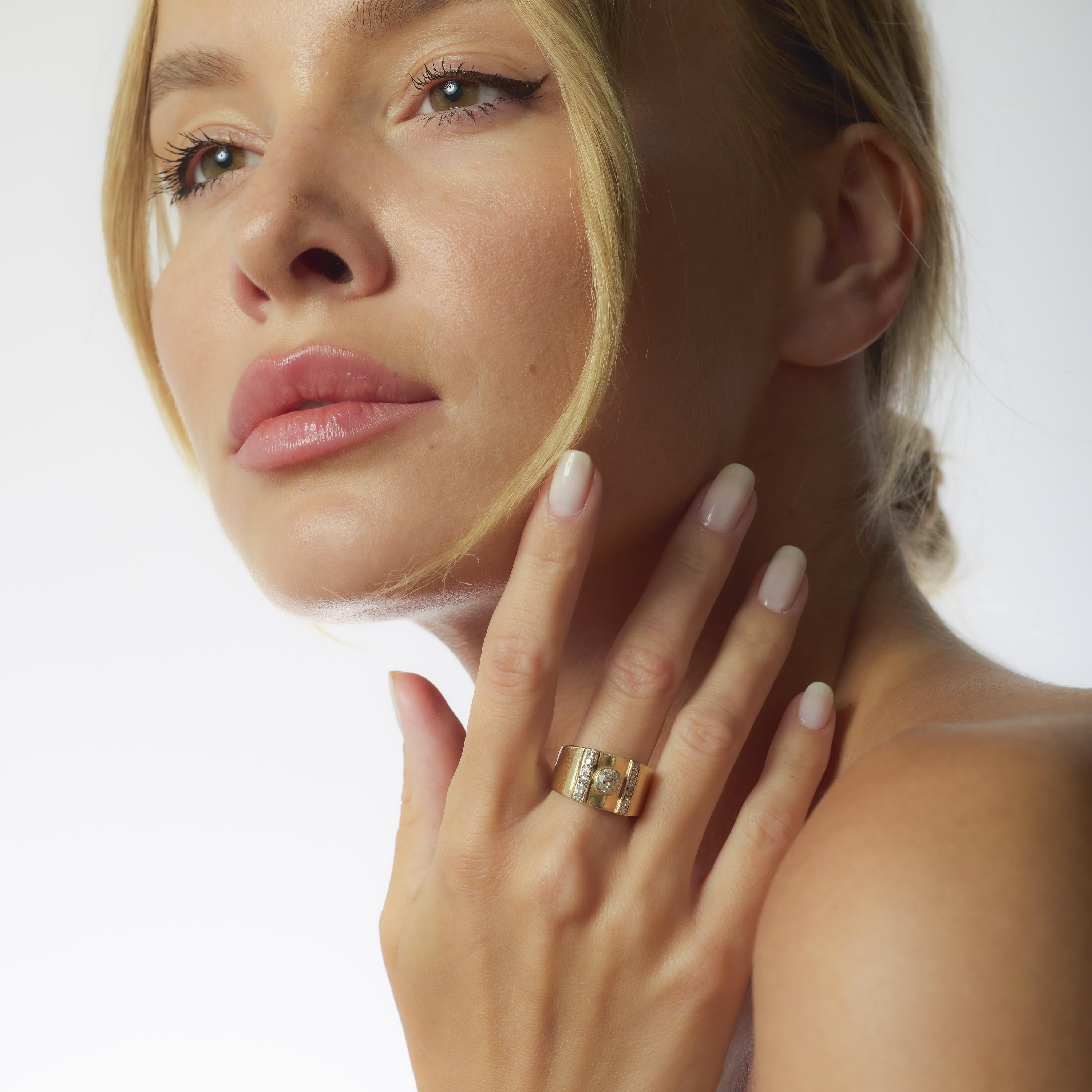 This Retro 14k yellow gold ring centers a warm .60 carat old European cut diamond, surrounded by twelve sparkling single cut accents. Crafted in the 1940s with bold presence and vintage charm, it’s a radiant reflection of mid-century
