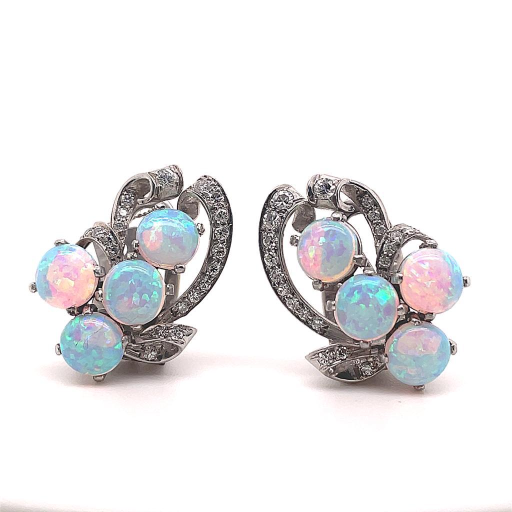 Retro opal and diamond platinum clip earrings, circa 1950.

An elegant pair of vintage opal and diamond set earrings, designed as a bunch of grapes. 
Each clip is set with a cluster of lively circular cabochon opals and a petal grain set with eight