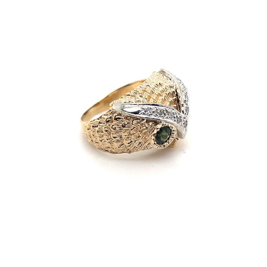 Alluring three-dimensional figural owl head ring.  14K yellow gold stylized feathers and beak, faceted green tourmaline eyes, rimmed with diamonds set in white gold.  Size 6 3/4 and can be custom sized.  American. Circa 1940's.  So realistic