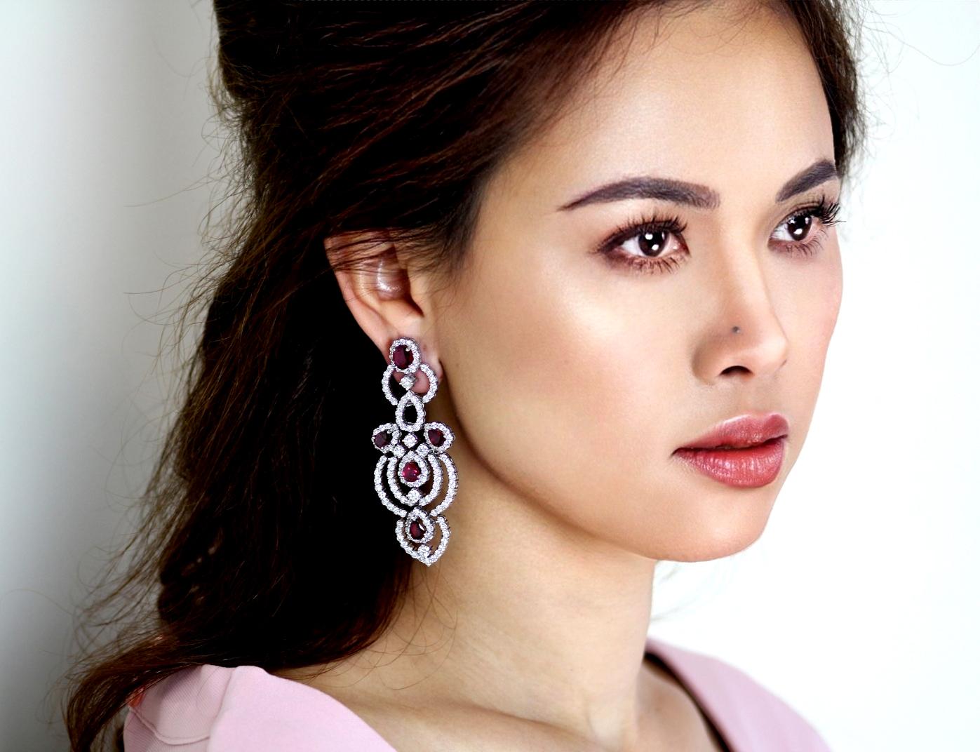 Beautiful openwork design, set throughout with courses of brilliant-cut diamonds, accented by pear-shaped and oval-cut ruby clusters with butterfly fittings.  These statement earrings will ensure that all eyes are on you. An immaculate pair of red