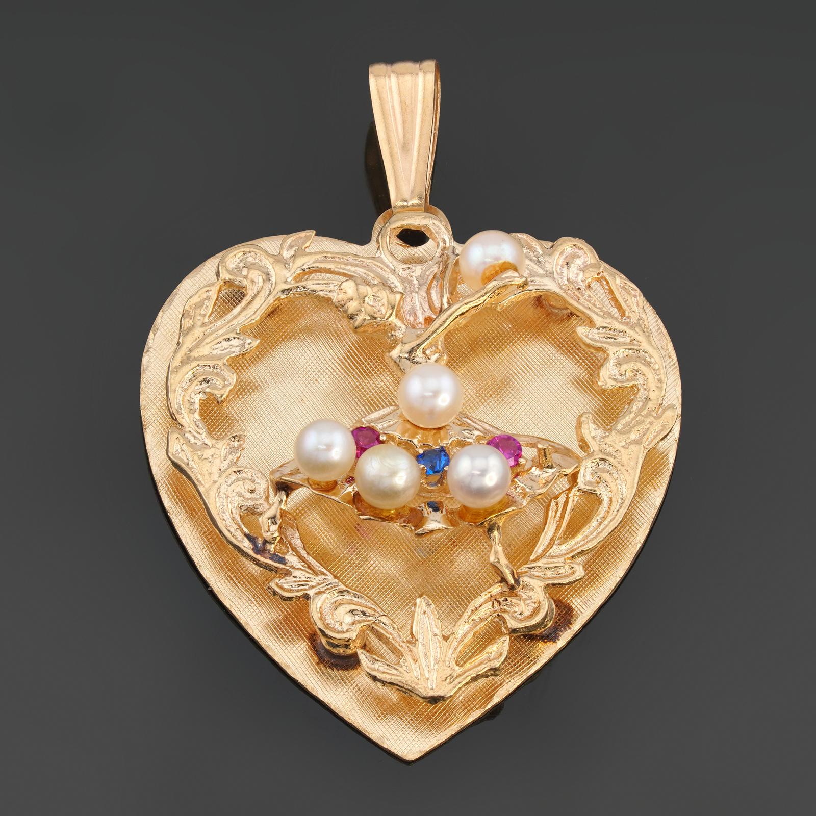 This gorgeous vintage retro heart-shaped pendant is crafted in 14k yellow gold and features a ballerina motif accented with cultured pearls and synthetic color gemstones.  Made in United States circa 1960s. Measurements: 1.22