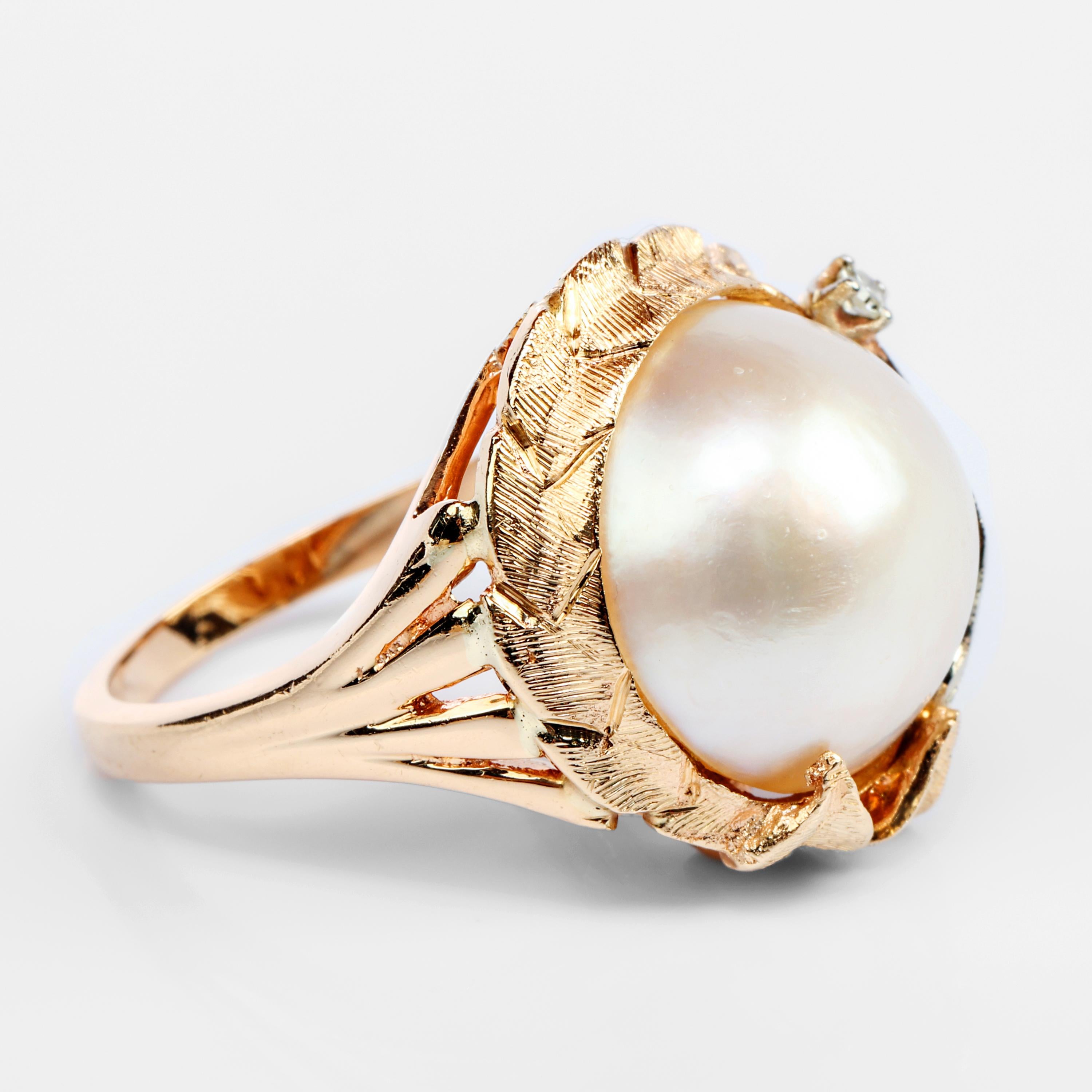 Created in the 1960s by New York designer, Harold Freeman, this retro-inspired ring is a little whirlwind of Hollywood glamour. Crafted in rich 14k yellow and white gold, the large (14.25 mm) mabe pearl is surrounded by a sort of frame of etched