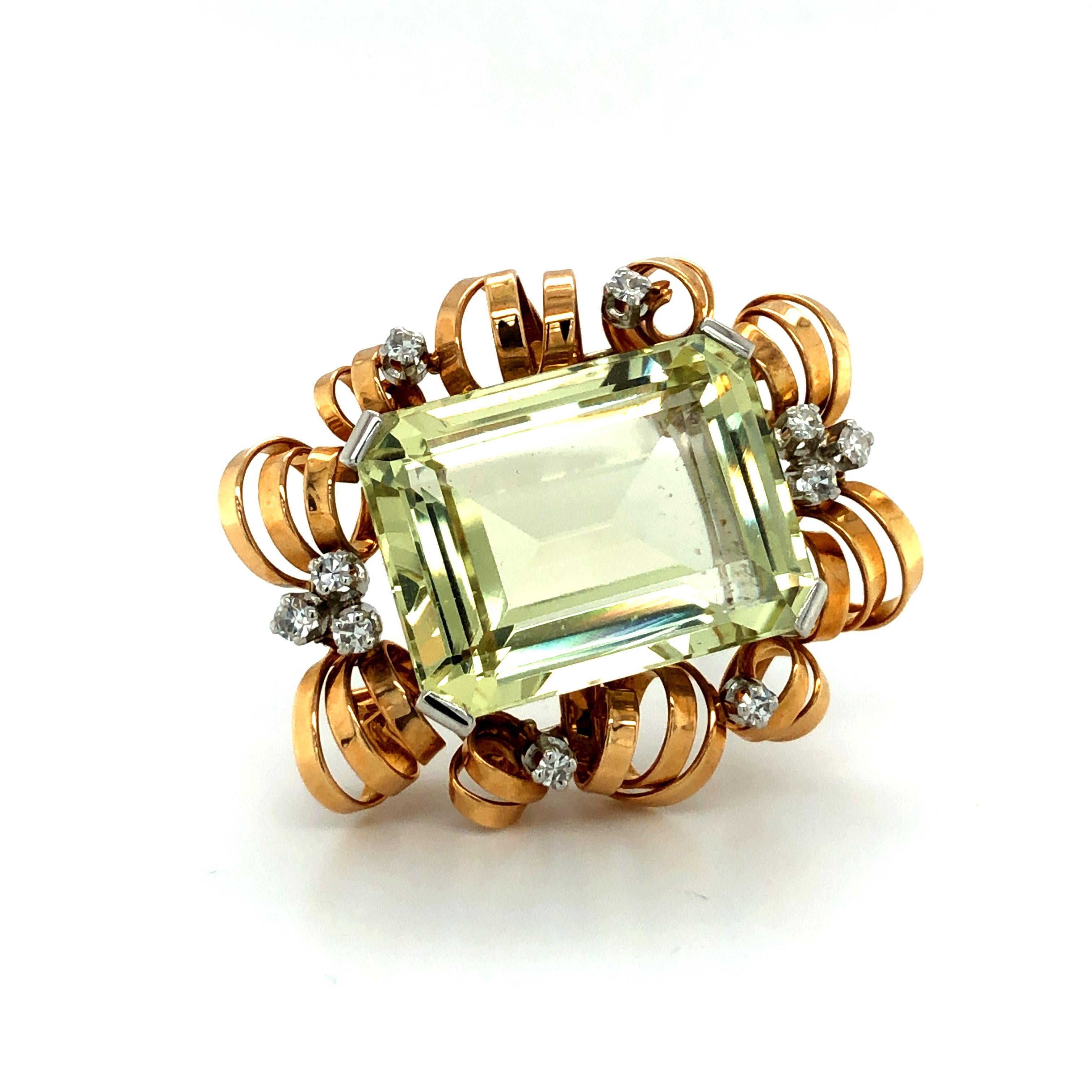 This fabulous retro pendant/brooch features a 30.00 carat yellowish green emerald-cut Beryl. Set amidst airy scrolls in 18 karat rose gold and accented with 10 single-cut diamonds of G/H colour and vs/si clarity, total weight approximately 0.45