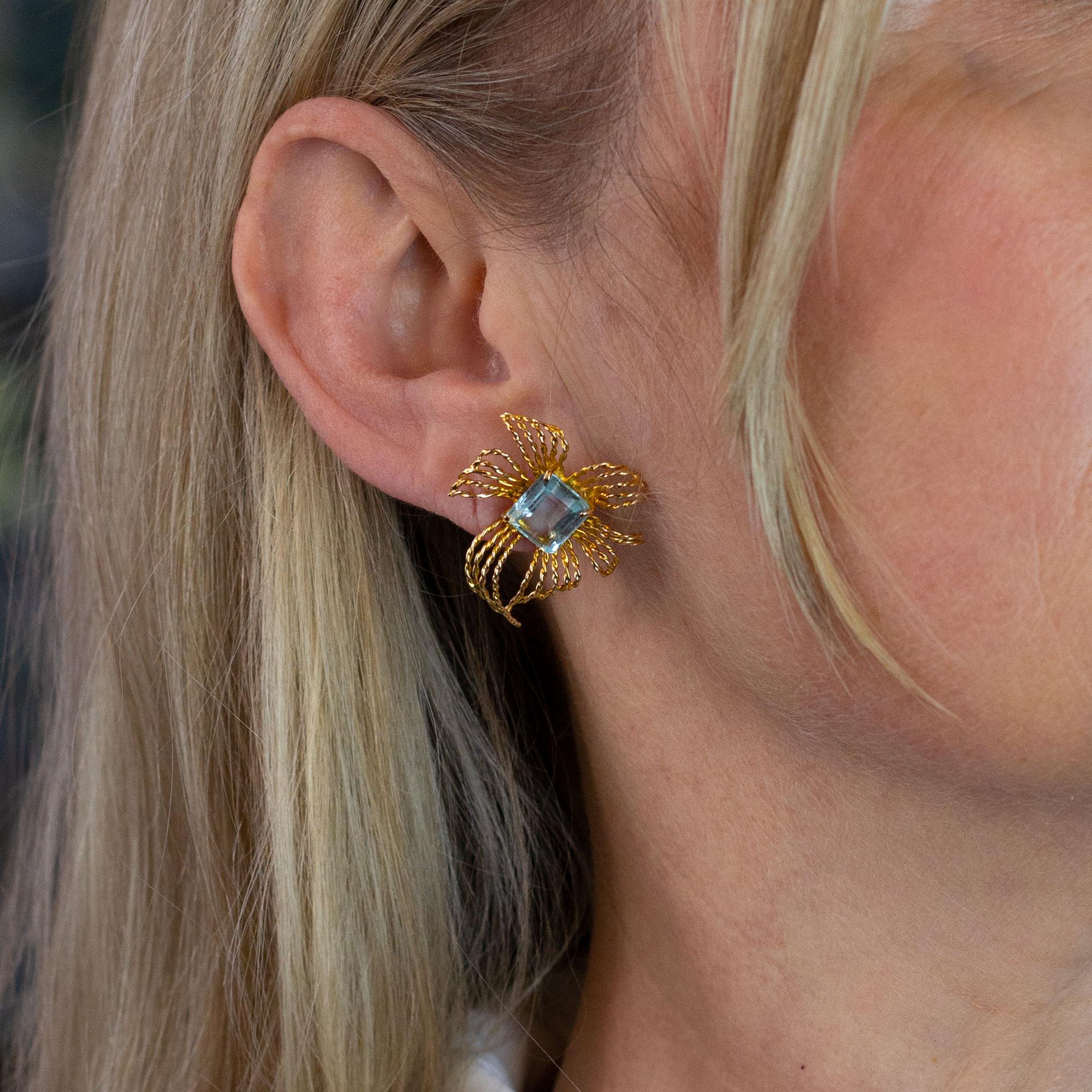 A very fine pair of Retro period aquamarine and gold earrings. These earrings are crafted from 10 karat yellow gold and are each set with a 2.4 carat octagonal cut aquamarine. The posts on this pair are threaded (screw on) so that they remain