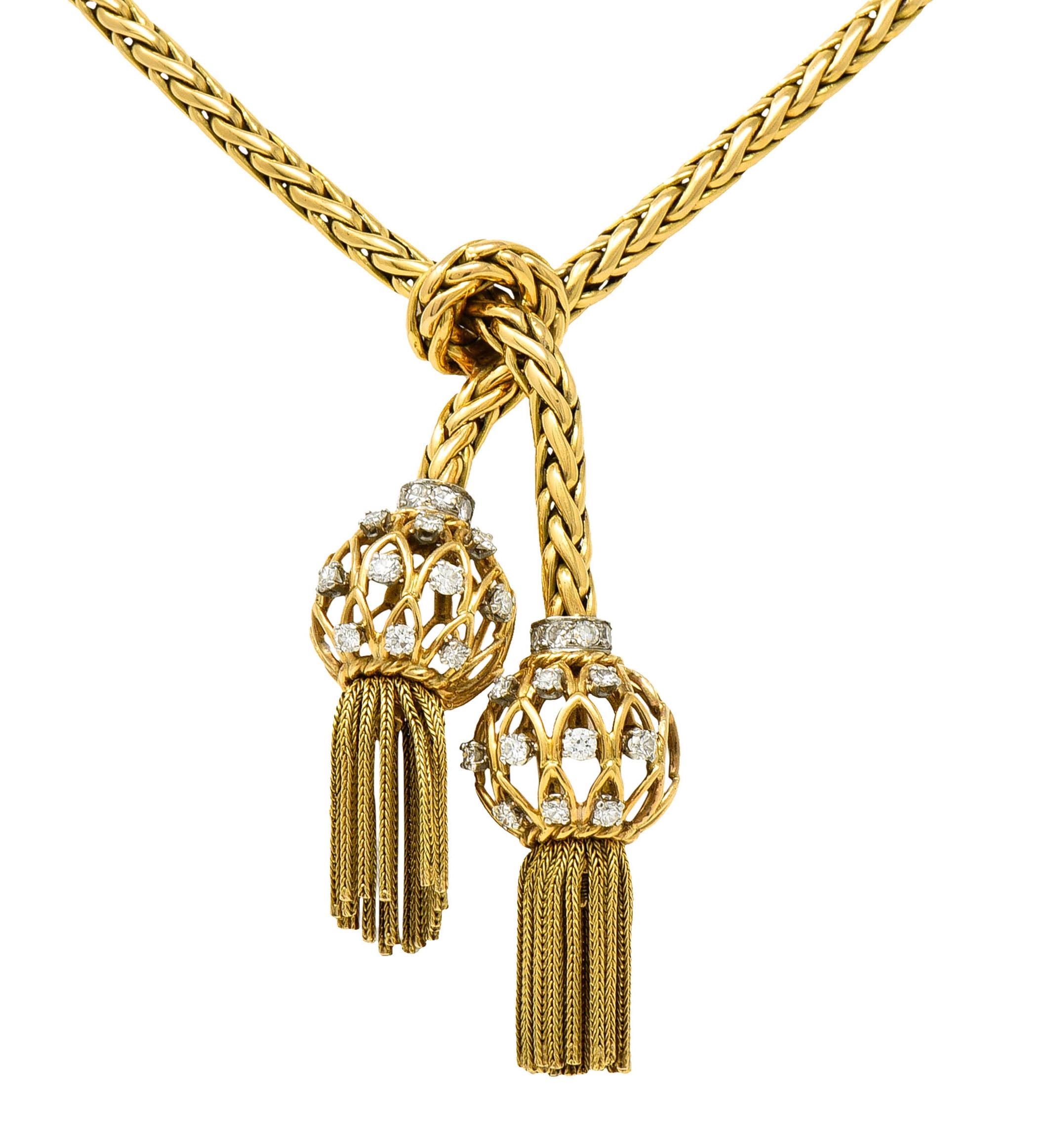Designed as a woven rope style necklace, knotted, and terminating in open wire orbs with tassels

Orbs are set with single and full cut diamonds, weighing approximately 1.15 carats total, G/H color and VS to SI clarity

With a concealed clasp making