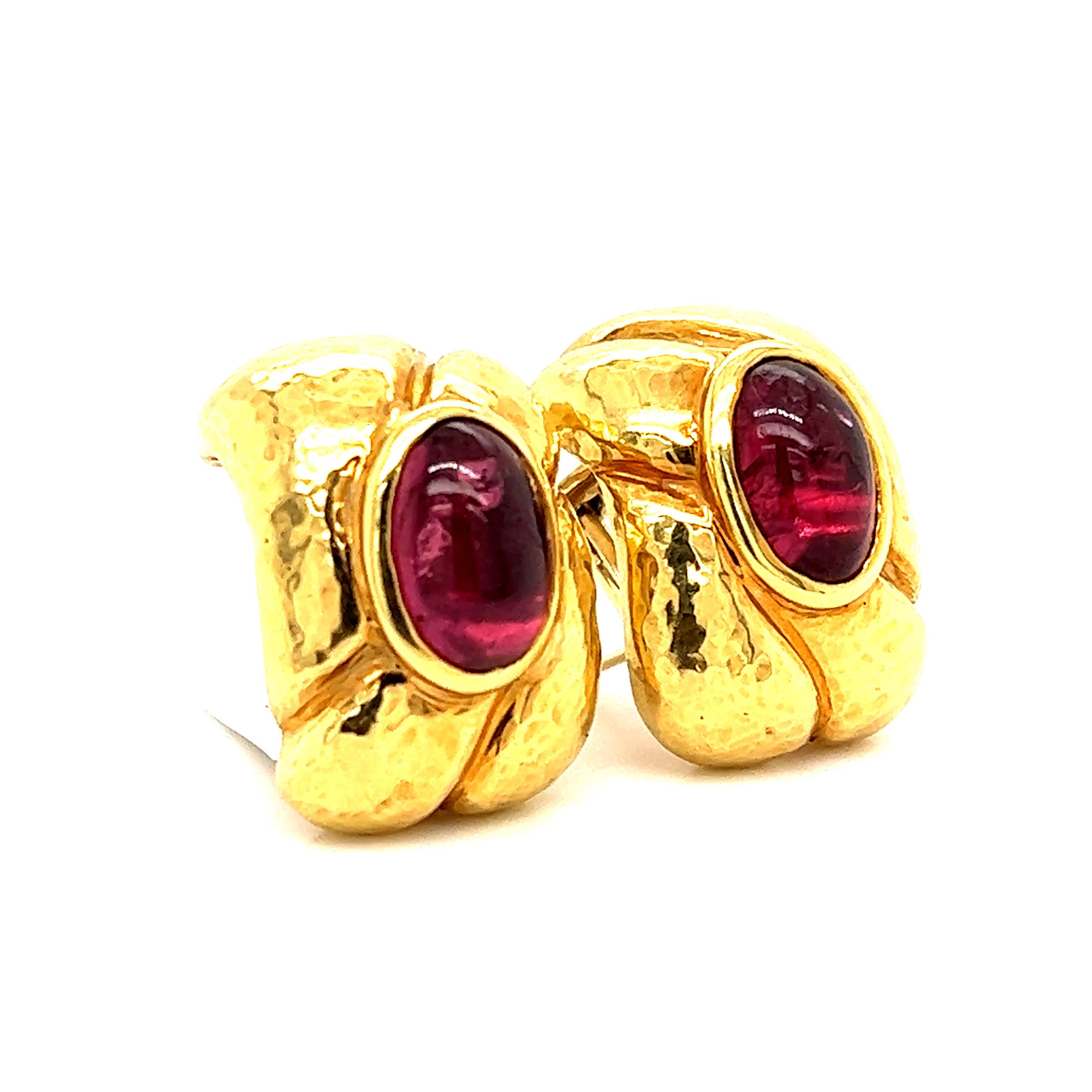 Gorgeous appeal on this retro pair of 18k yellow gold earrings. Highlighting the pair are two cabochon cut pink tourmaline gemstones that display a rich pink tone that contrast perfectly against the yellow gold design. The gemstones are bezel set