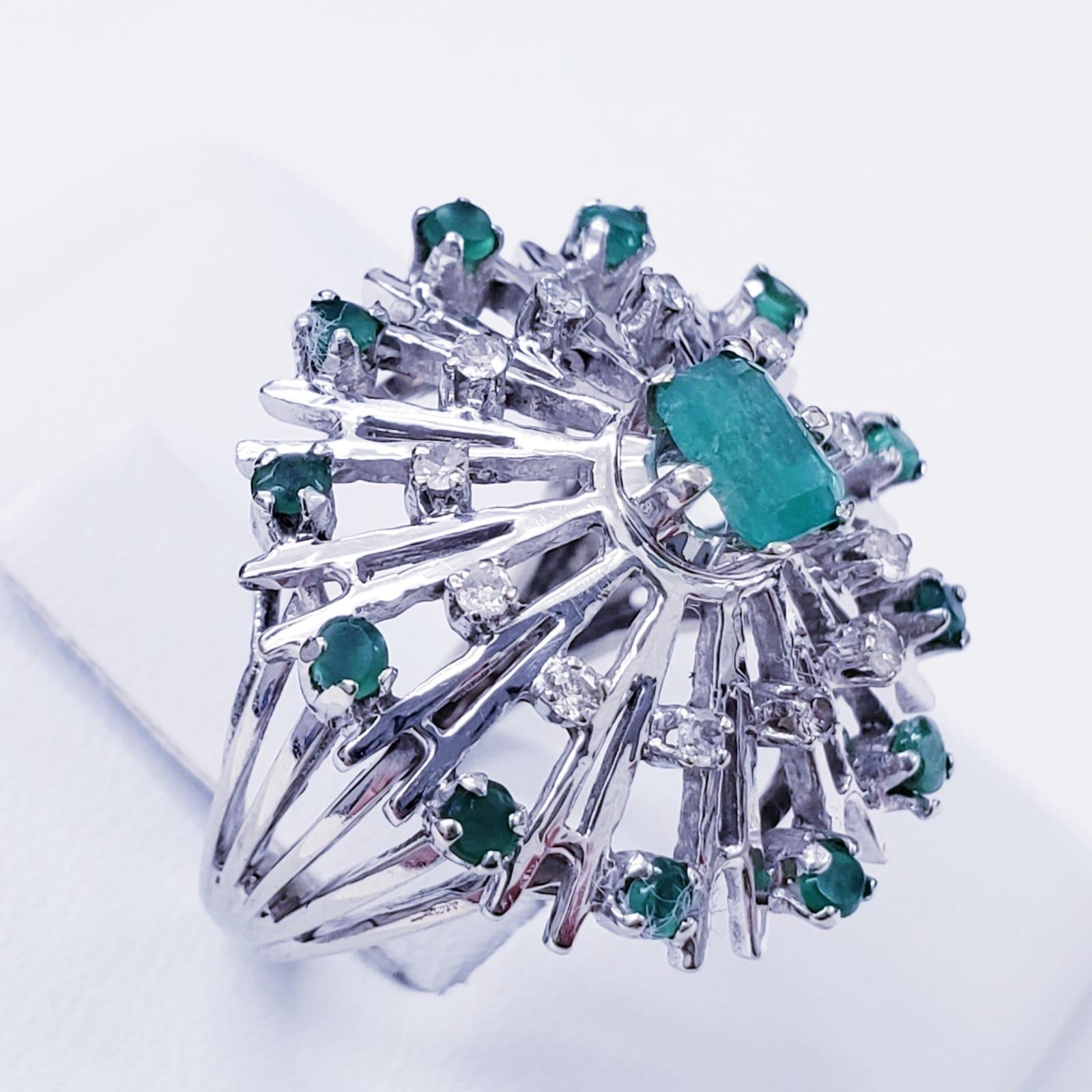 Vintage 1.00 Carat Total Weight Emeralds and Diamonds Cluster Cocktail Ring. The ring is made of 18 karat and features approx total emerald carat weight 0.70ct & approx 0.30ct Diamonds. The ring size is 4. The ring weights 7.8 grams. The ring