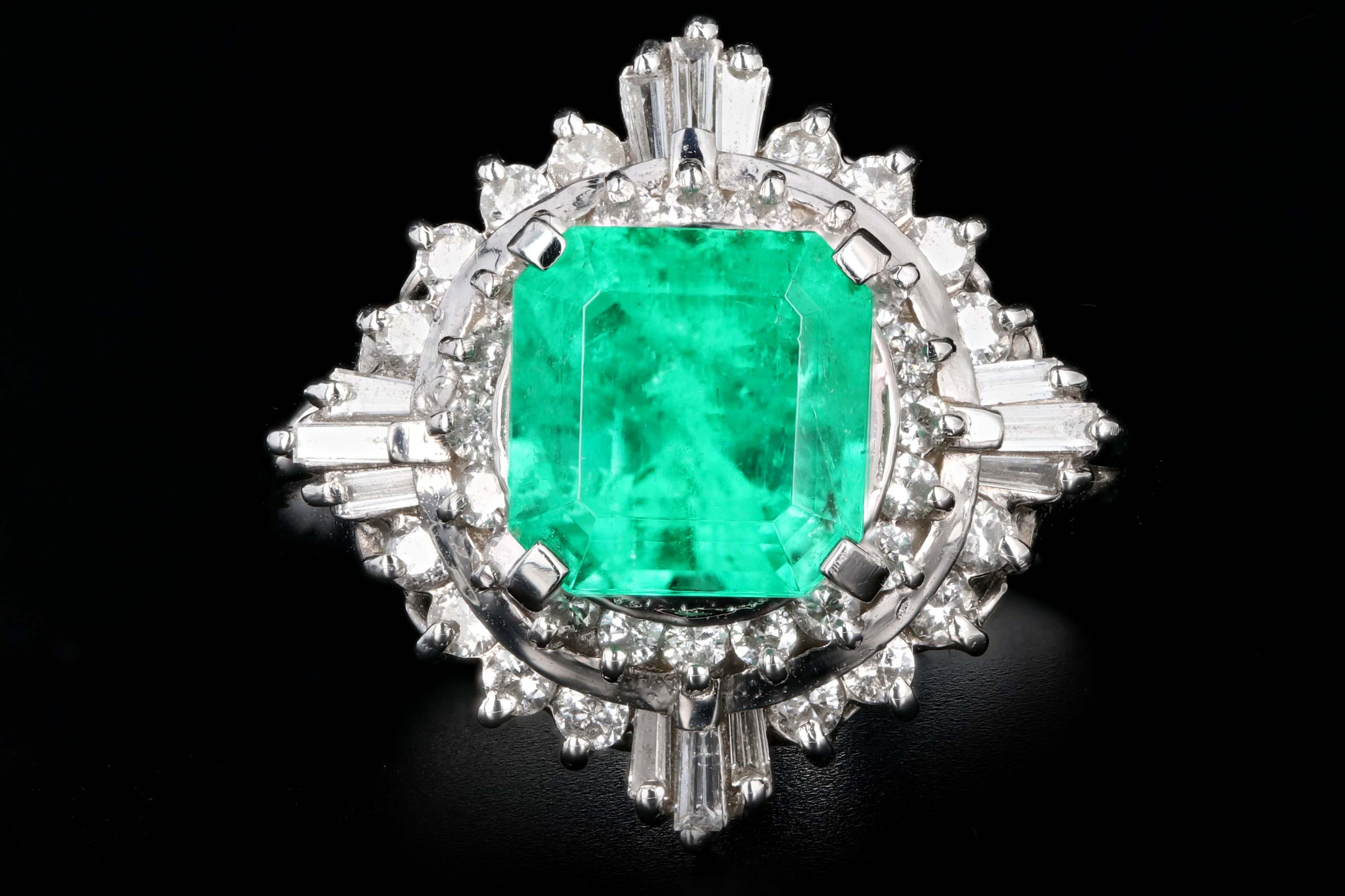 Era: Retro

Composition: Platinum

Primary Stone: Emerald

Carat Weight: 1.83 Carats

Accent Stone: Round Brilliant Cut & Tapered Baguette Cut Diamonds

Carat Weight: .56 Carats

Color: G-H

Clarity: Vs1/2

Total Carat Weight: 2.39 Carats

Ring