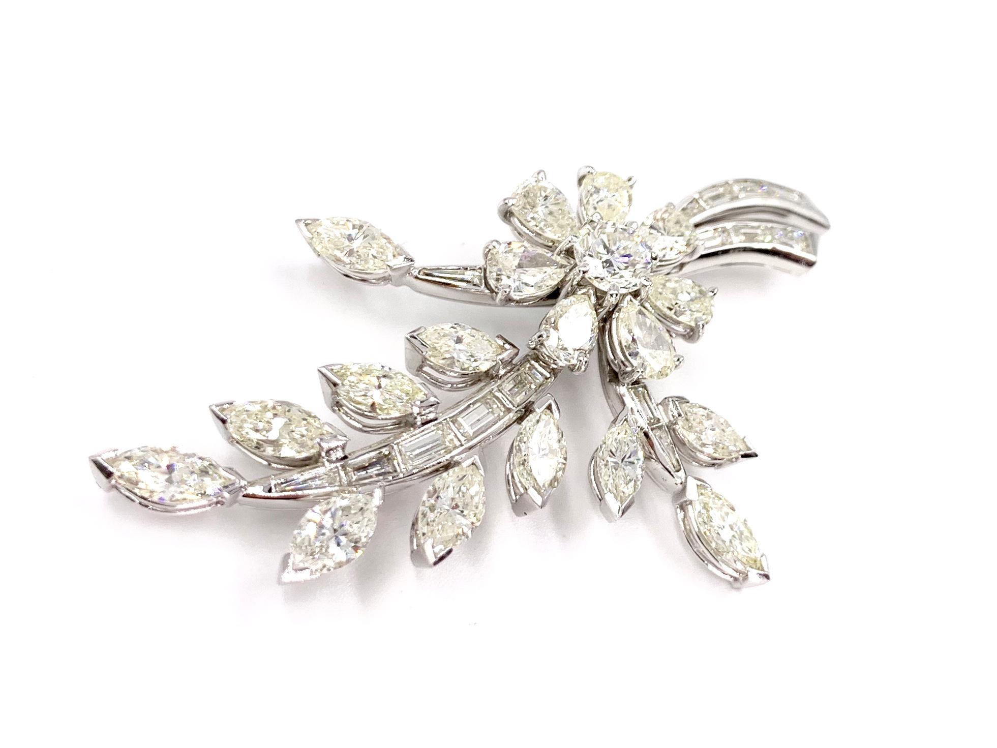 An elegant and feminine floral platinum diamond spray brooch. The flower showcases a .62 carat round brilliant diamond center (approximately I color, VS2 clarity) surrounded by seven pear shape diamond petals at approximately 1.80 carats total
